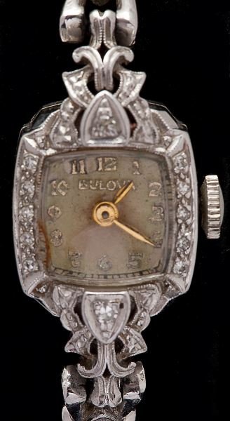 Lady's Diamond Watch, Bulova: Lady's Diamond Watch, Bulova rectangular champagne dial with Arabic numerals and set within a diamond bezel, link bracelet with diamond melee and terminating in fold over safety clasp, case back stamp