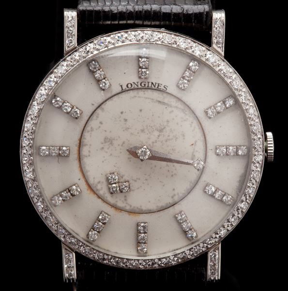 Lady's Diamond "Mystery Hand" Wristwatch, Longines: Lady's Diamond "Mystery Hand" Wristwatch, Longinesdesigned as a round case, the dial set with diamond baton indicators, to the diamond set hour hand which appears to float due to the unique mechanism,