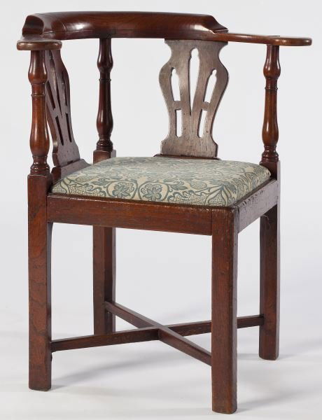 English Chippendale Corner Chair: English Chippendale Corner Chair18th century, elm wood, having the typical form of a continuous curved rail over turned supports and pierced splats, straight legs with cross stretcher base.30 x 26.5 x
