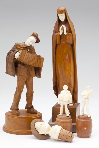 A Group of Five Carved Ivory and Wood Figures: A Group of Five Carved Ivory and Wood Figures 20th century, likely Black Forest origin: a Madonna on marble plinth (10 in.); an accordion player (8 in.); (2) musicians each standing upon a barrel (4 i