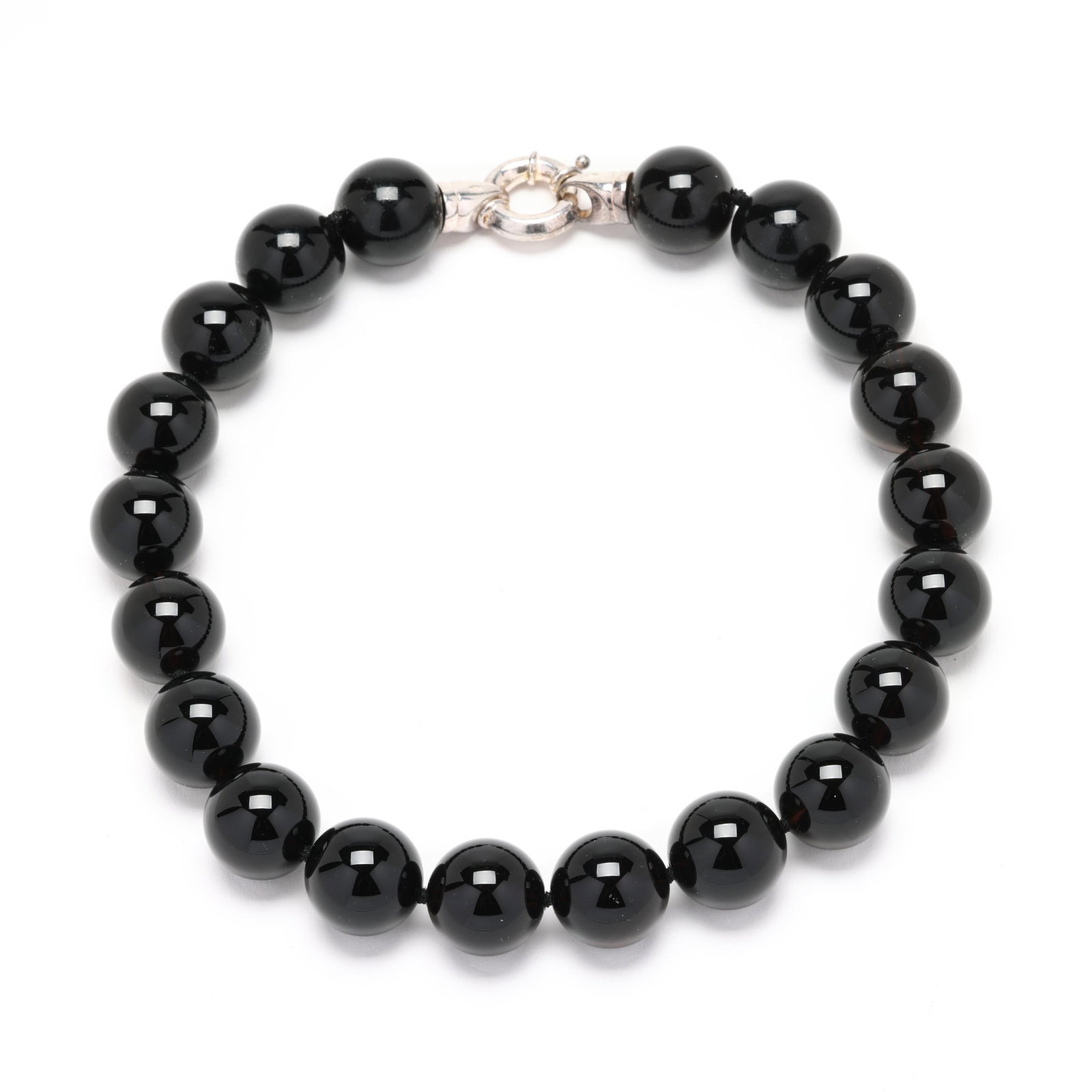 Black Onyx Bead Necklace with Silver Clasp: Black Onyx Bead Necklace with Silver Claspsingle strand of (20) strung knotted round black onyx beads (20mm) and completed with a bold spring ring clasp stamped 925. 18 in. Additional high-resolution