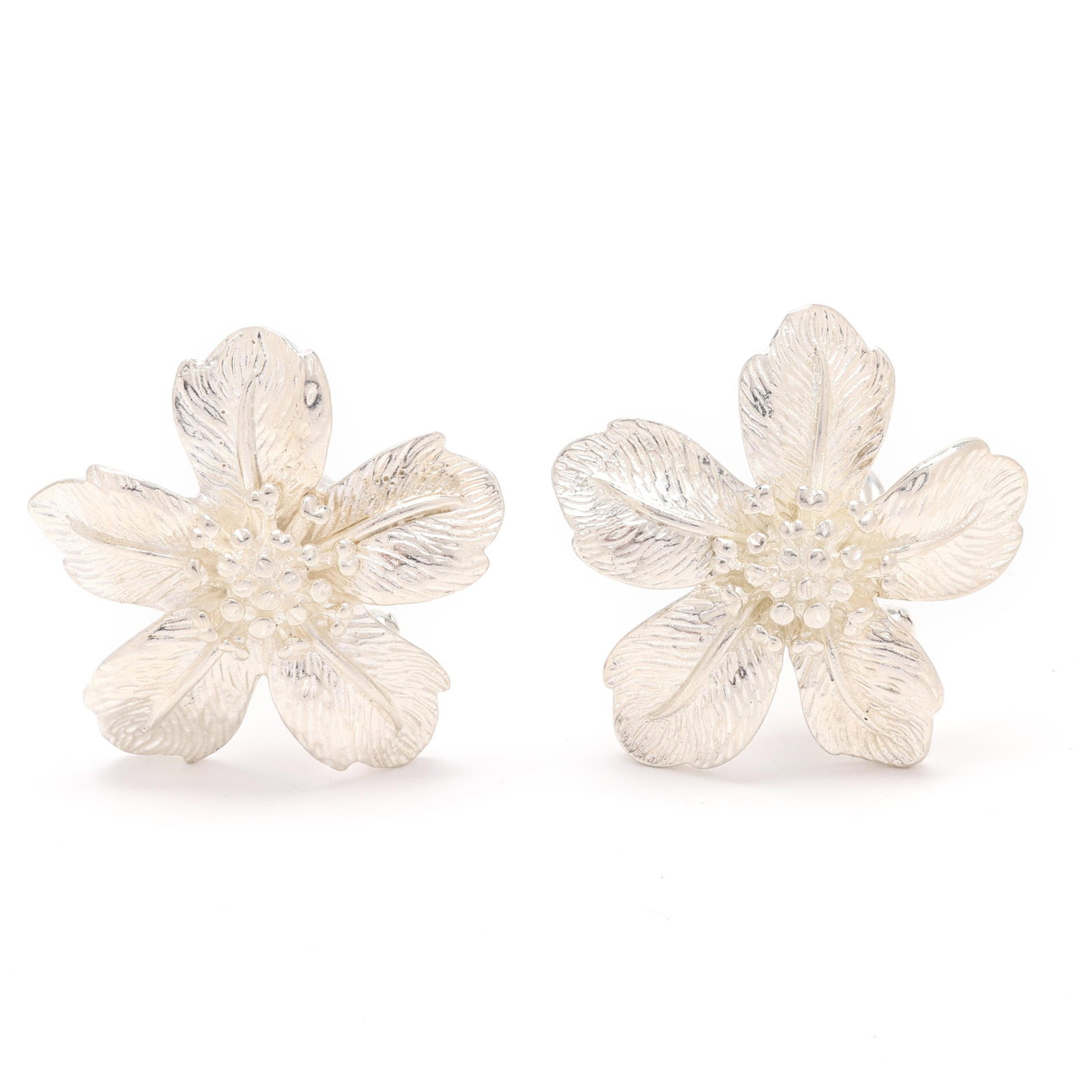 Pair of Silver Flower Motif Earrings, Tiffany & Co.: Pair of Silver Flower Motif Earrings, Tiffany & Co. the flower design earrings with textured petals, completed with posts and omega clip backs, stamped T & Co. and 925. 1 in. .45 troy oz. Private Coll