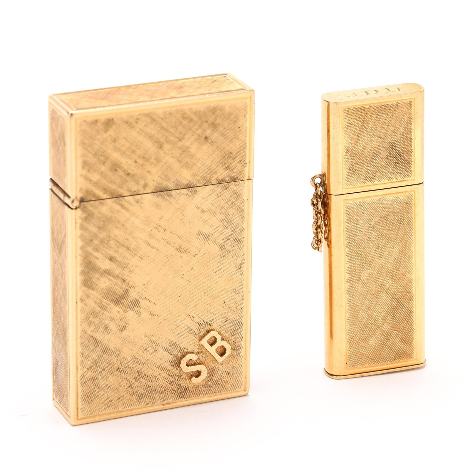 Two Vintage Gold Lighters: Two Vintage Gold Lightersto include: a gold cased lighter with Florentine finish and applied monogram SB, hinged lid, case stamped 14K and with maker's mark B&A, interior stamped Zippo (2 1/16 x 1.25