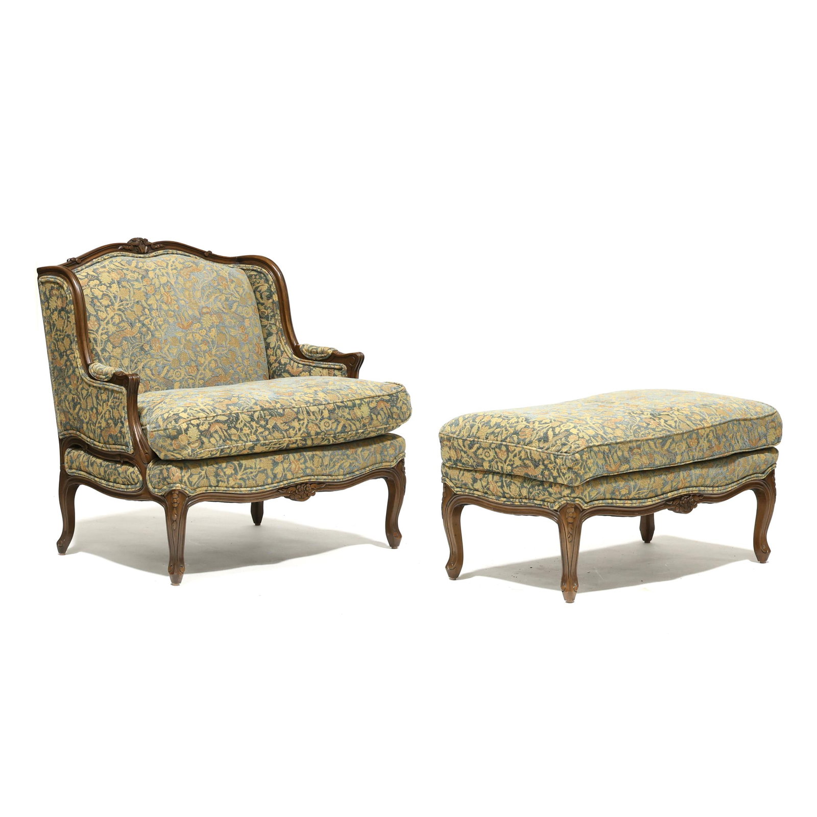 TRS Furniture, Oversized Bergere and Ottoman: TRS Furniture, Oversized Bergere and Ottomanlate 20th century, carved wood frame, plush floral upholstery with peacock blue field, loose seat cushion, cabriole legs, labeled. Chair 38 x 27 x 26 in. Pr