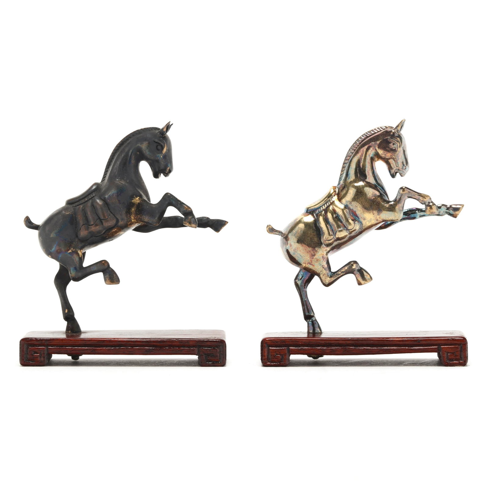 A Pair of Miniature Chinese Silver Horses on Stands: A Pair of Miniature Chinese Silver Horses on Stands20th century, includes a patinated and gold toned horse, marked "925" under abdomens, fitted with carved stands, retaining original boxes. Horse 3 1/
