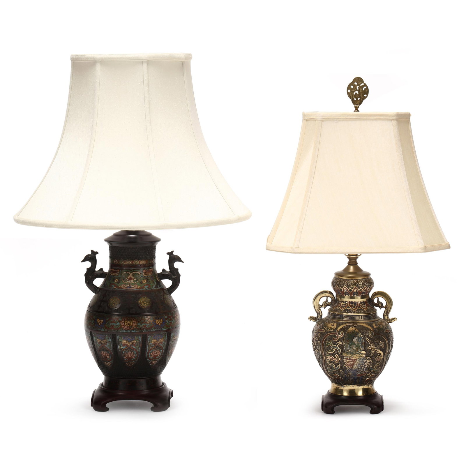 Two Asian Champleve Table Lamps: Two Asian Champleve Table Lamps mid 20th century, includes a bronzed and brass lamp, each relief decorated and enameled, raised on carved wood bases, with double handles, fitted with shades. The large