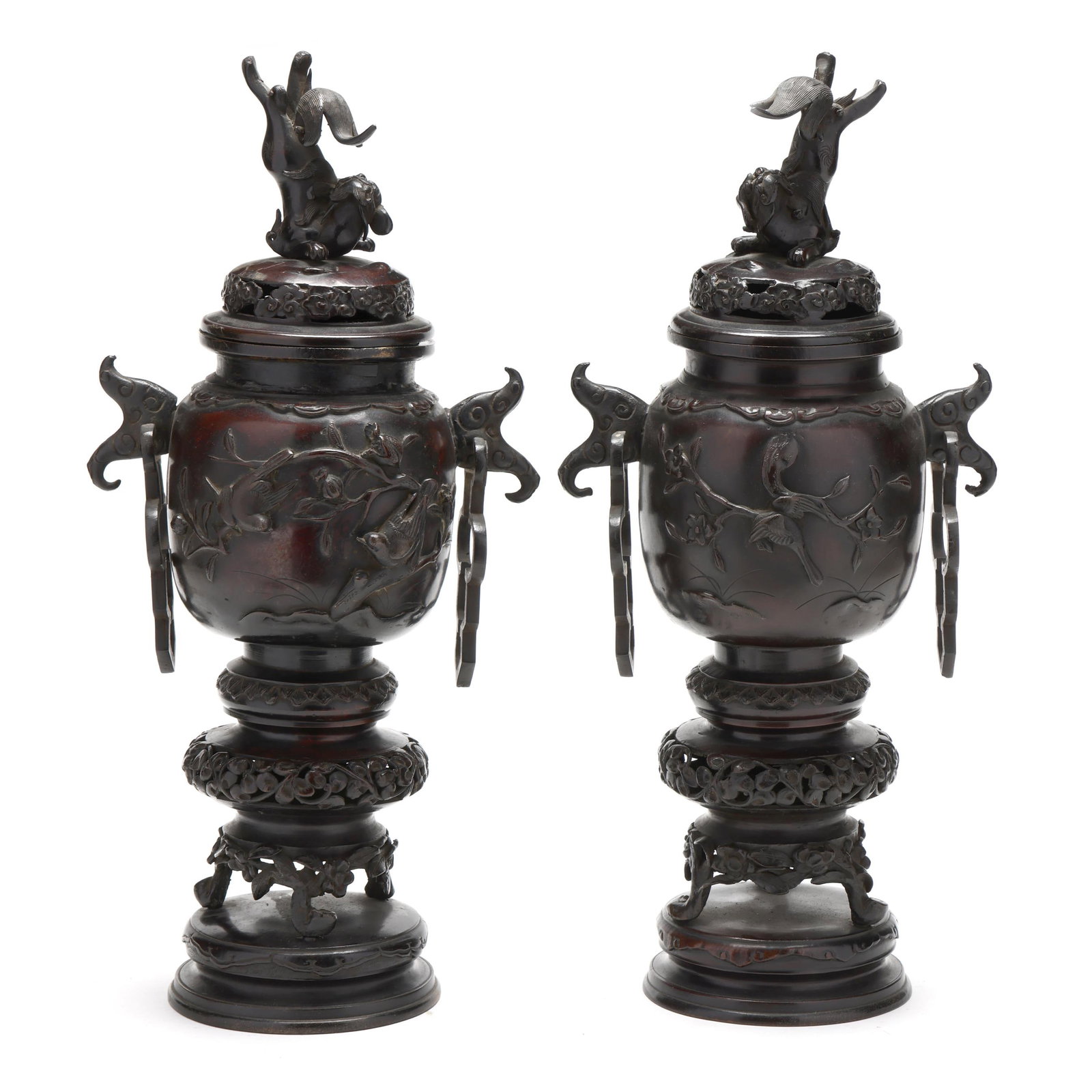 A Pair of Japanese Bronze Covered Censers: A Pair of Japanese Bronze Covered Censers Meiji period (1868-1912), a finely cast pair of patinated bronze covered vessels of baluster form, each decorated in relief with birds perched among flowering