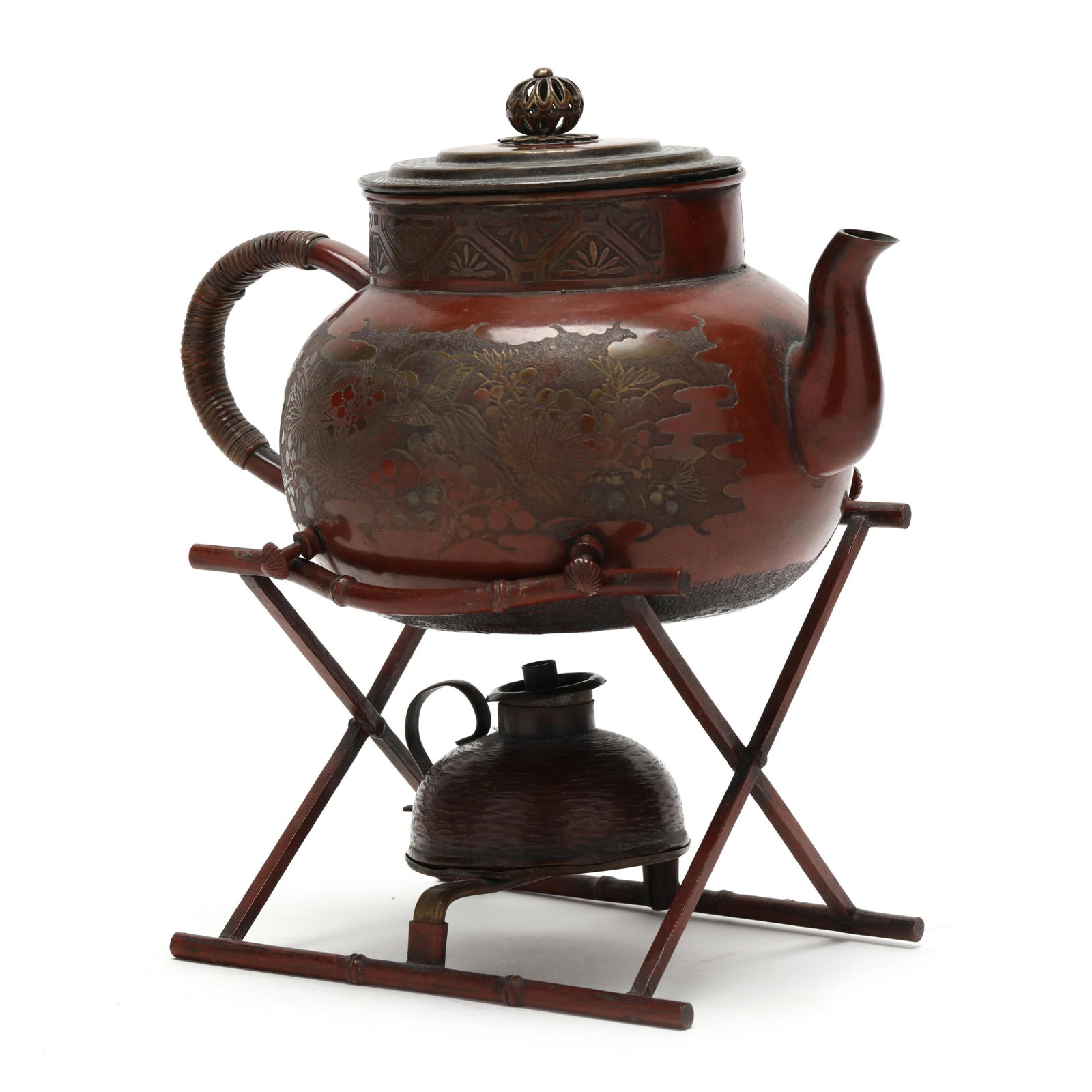 A Japanese Mixed Metal Teapot with Bamboo Stand and Warmer: A Japanese Mixed Metal Teapot with Bamboo Stand and Warmer Meiji period (1868-1912), 19th century, a copper and mixed metal tea kettle of compressed globular form with shaped spout, wrapped handle, an