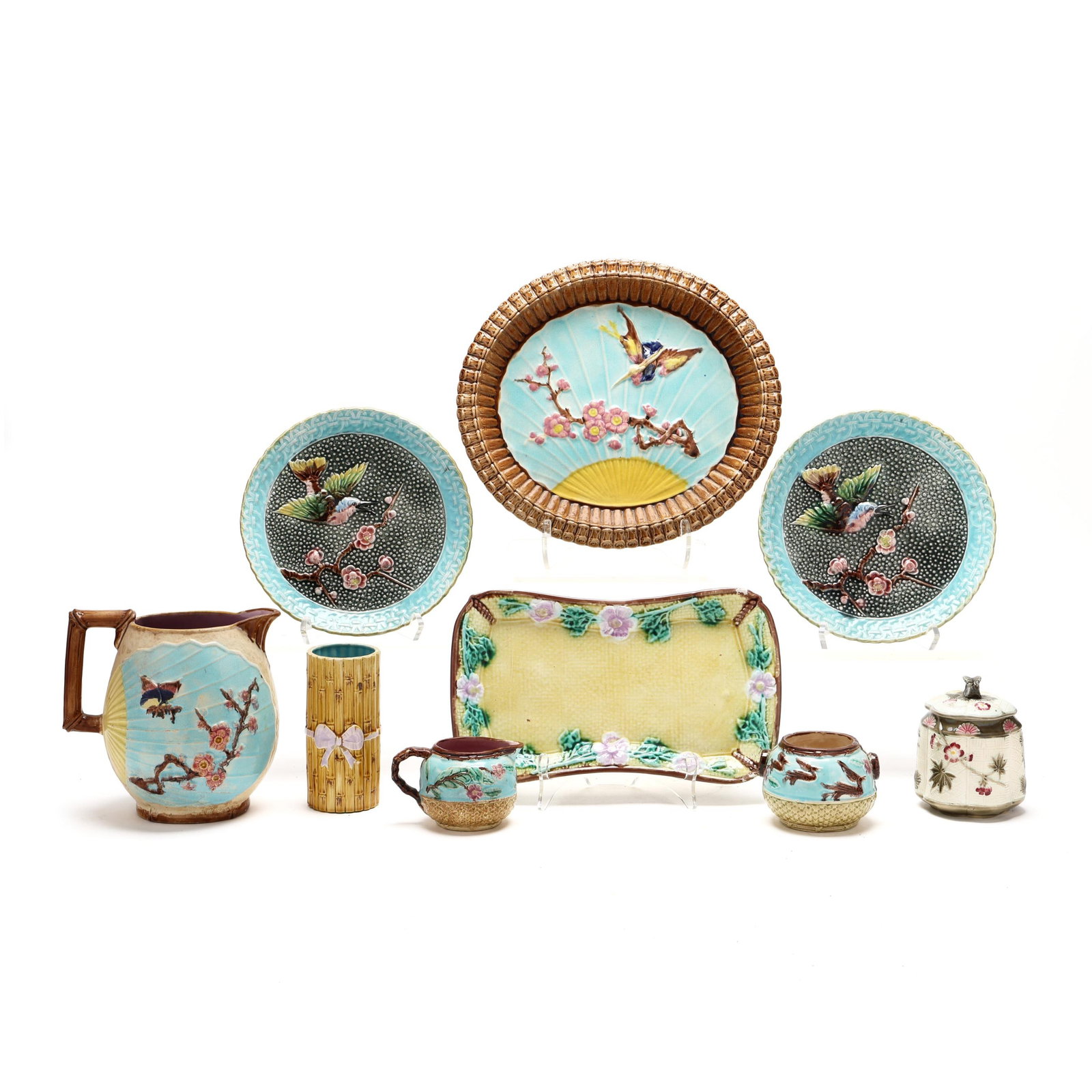 Nine Pieces of Assorted Majolica Tableware: Nine Pieces of Assorted Majolica Tableware assorted tin-glazed earthenware with butterfly, bird, and cherry blossom decoration, including a Wardle & Co pitcher, marked with patent stamp to underside (