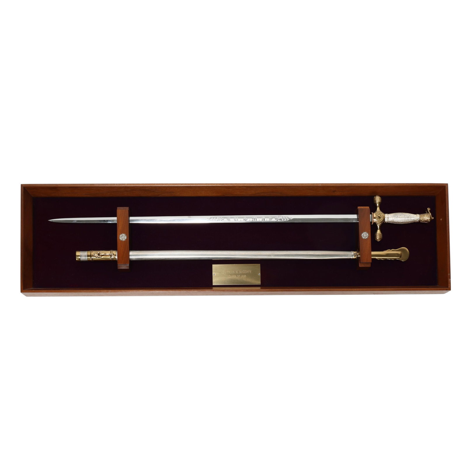 West Point Graduate's Presentation Sword & Scabbard In Display Box: West Point Graduate's Presentation Sword & Scabbard In Display Box This attractive weapon has a brass plaque naming owner PATRICK M. McGERTY/ CLASS OF 1985; the sword's 30 in. blade is engraved U.S.M.