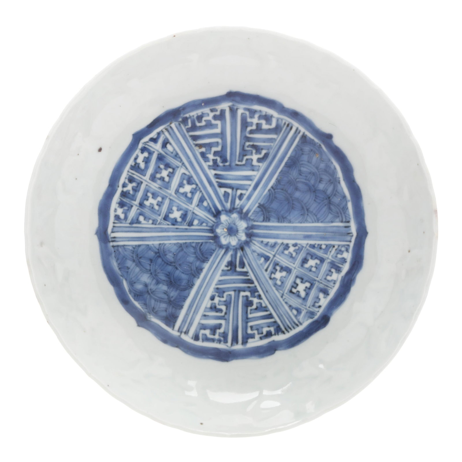 A Chinese Porcelain Blue and White Molded Dish: A Chinese Porcelain Blue and White Molded Dish Ming dynasty (1368-1644), porcelain hand painted in underglaze blue with a barbed rim medallion divided into six sections with repeating auspicious patte