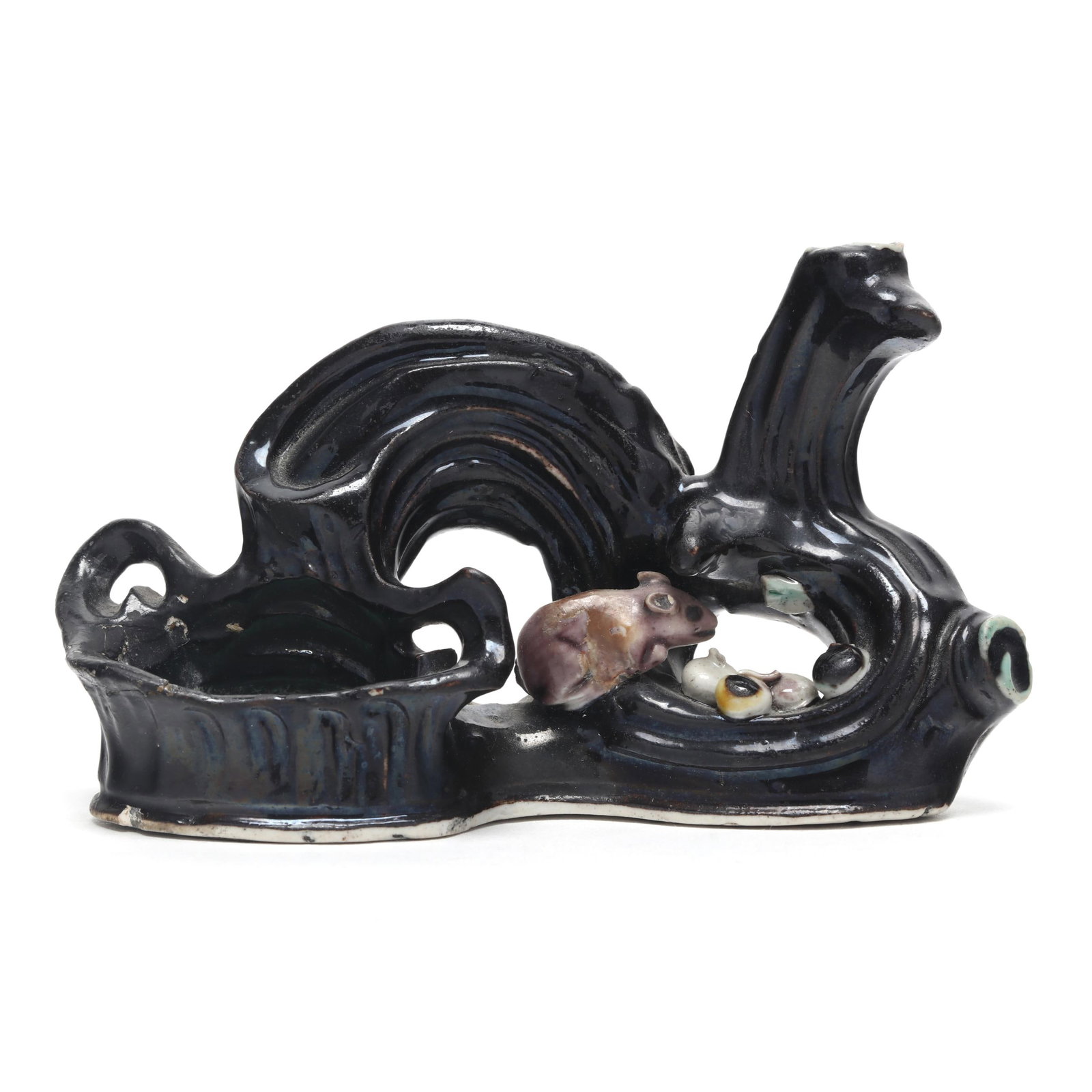 A Chinese Famille Noire Brush Rest and Brush Washer Coupe: A Chinese Famille Noire Brush Rest and Brush Washer Coupe Kangxi period (1662-1722), hand painted in black, green, and aubergine, shaped as a twisted gnarled branch with a small squrriel with acorns t