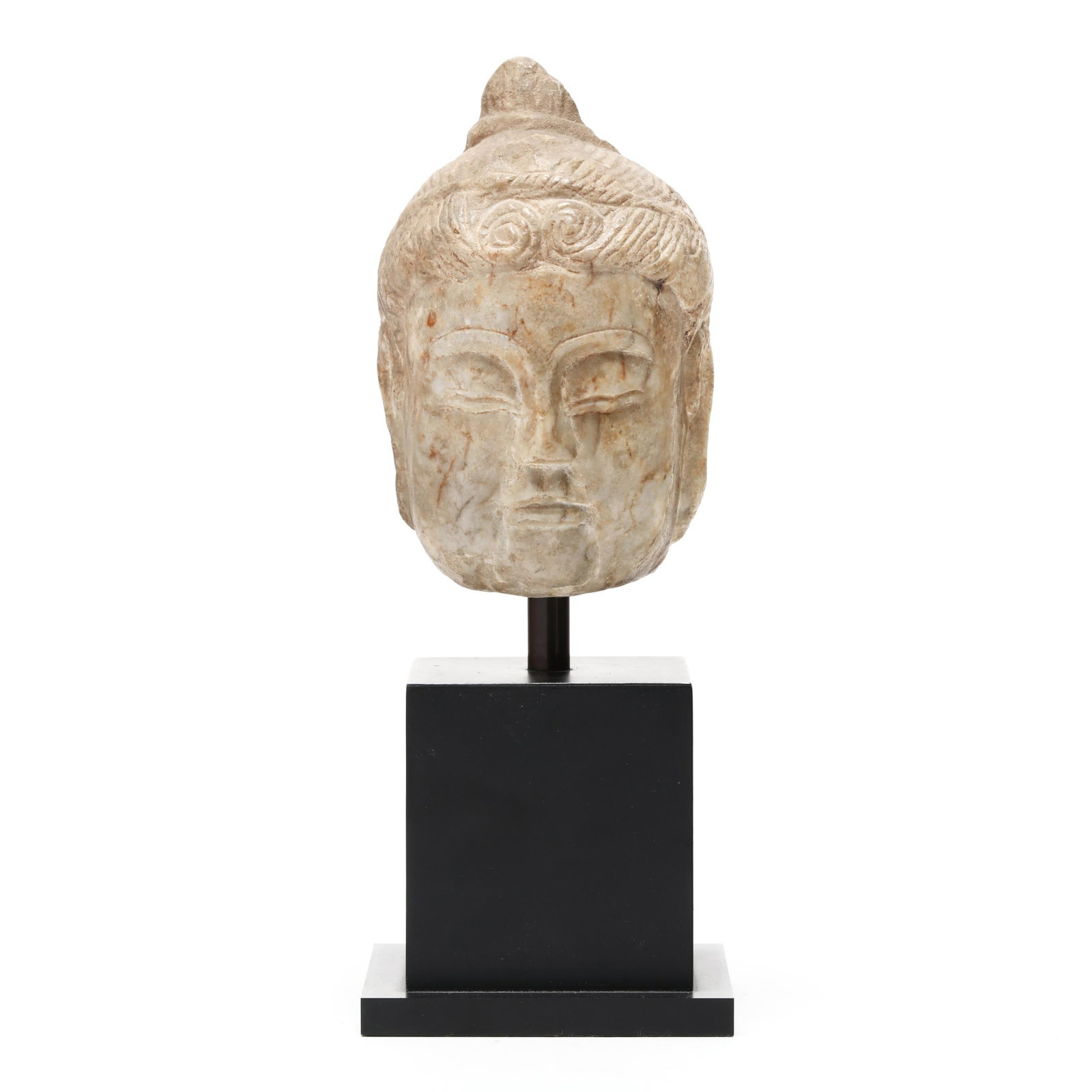 A Chinese Carved Marble Head of Buddha: A Chinese Carved Marble Head of Buddha Tang dynasty (618-907), marble skillfully carved with a rounded serene face having downcast eyes beneath gently arched brows, softly modeled cheeks and small pur