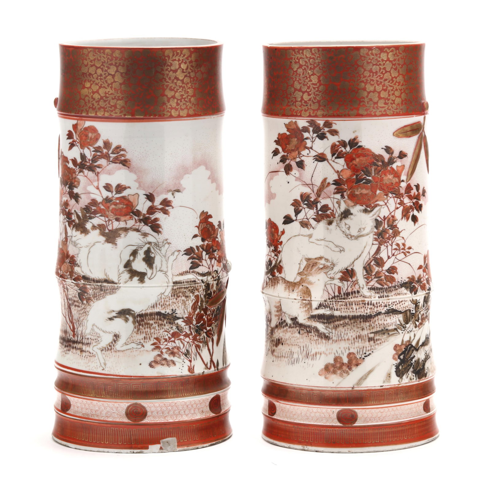 A Pair of Japanese Kutani Tall Vases with Cats: A Pair of Japanese Kutani Tall Vases with Cats Meiji period (1868-1912), a pair of tall bamboo shaped porcelain vases hand painted with playful cats frolicking in the grass amidst peonies, a thick gil