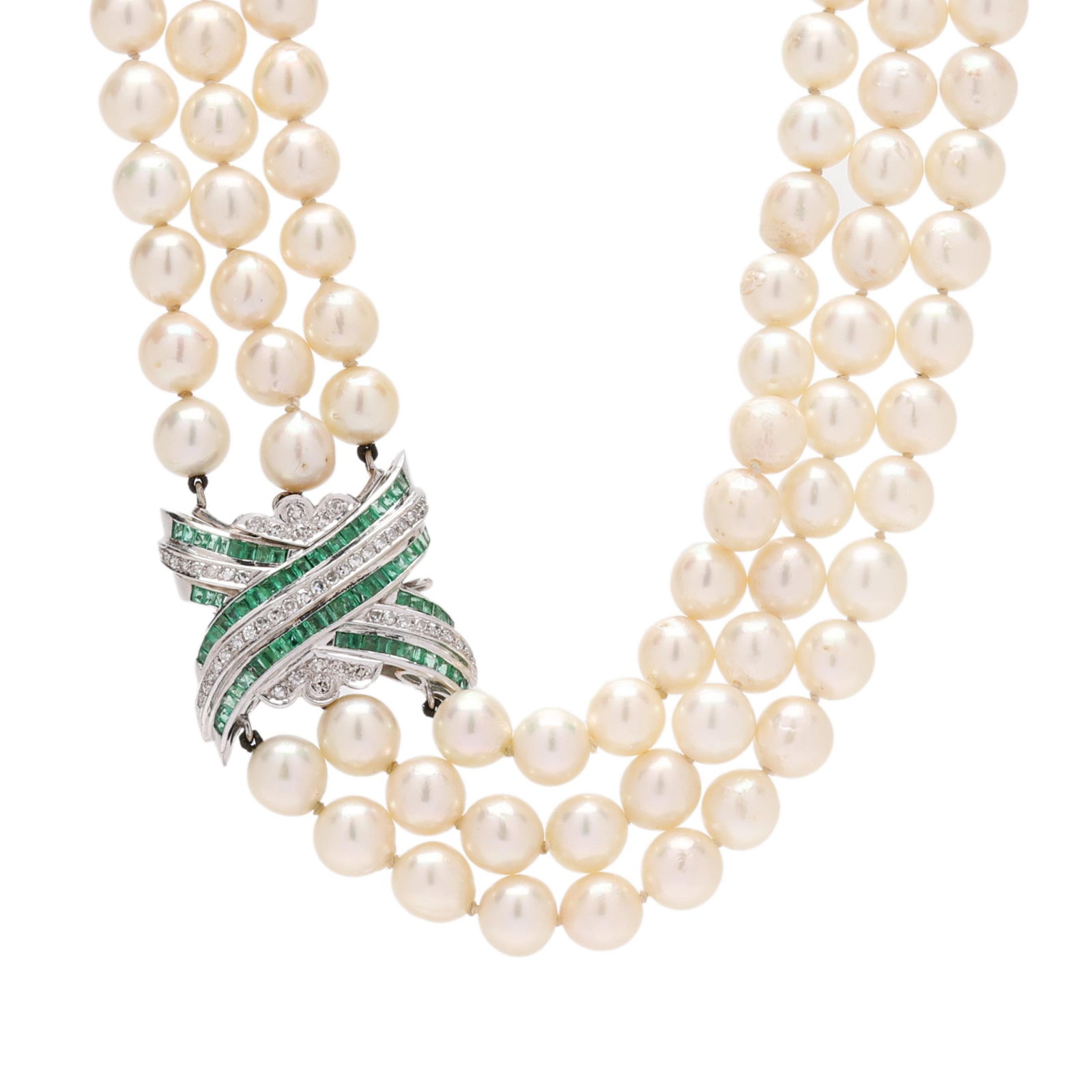 Triple Strand Pearl Necklace with White Gold, Emerald, and Diamond Clasp: Triple Strand Pearl Necklace with White Gold, Emerald, and Diamond Clasp three strung knotted strands of (52), (54), and (57) off-round cultured pearls (8.5mm to 9.0mm), completed with an X motif whit