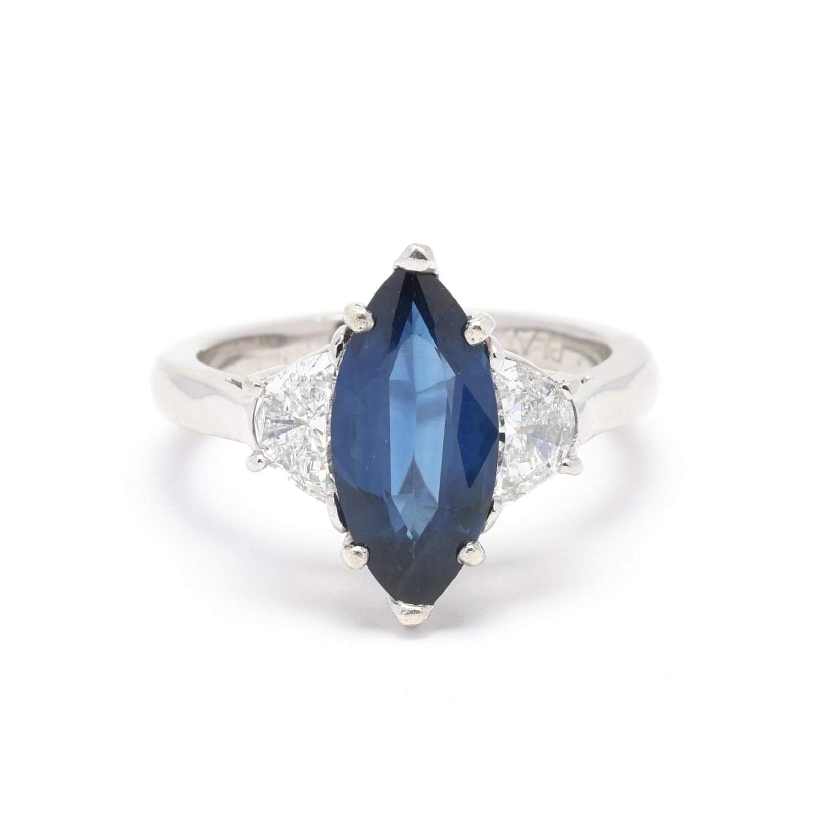 Platinum, Sapphire, and Diamond Ring: Platinum, Sapphire, and Diamond Ring centered on a marquise cut sapphire (13.00 x 6.45 x 3.40mm) weighing approximately 1.80 carats and set to each side with a half moon cut diamond (6.25 x 4mm) (G-H 
