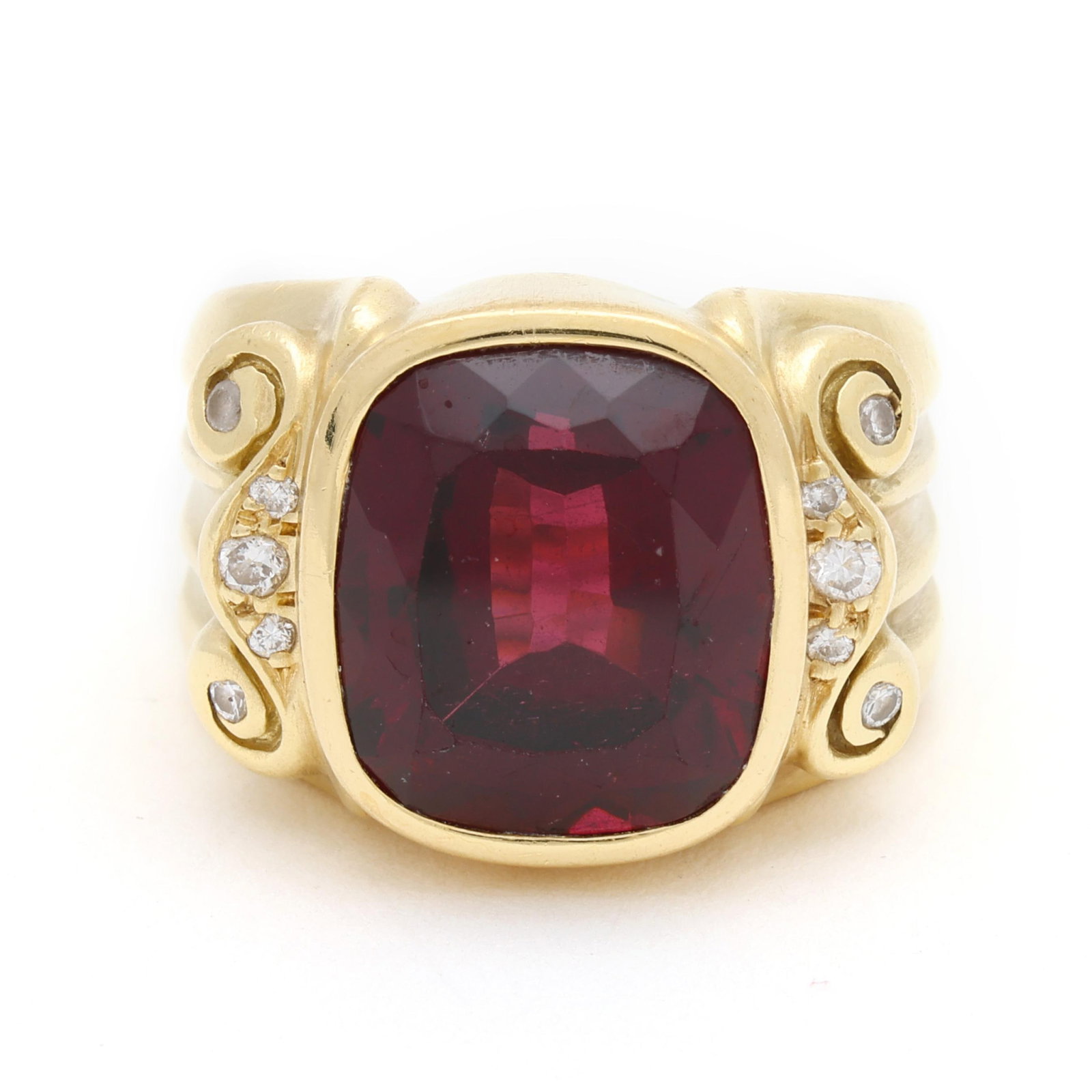 Gold, Rhodolite Garnet, and Diamond Ring: Gold, Rhodolite Garnet, and Diamond Ring centered on a bezel set cushion cut rhodolite garnet (13.5 x 11.7 x 7.6mm) weighing approximately 11.50 carats, with scrolled motif to shoulders set with full 