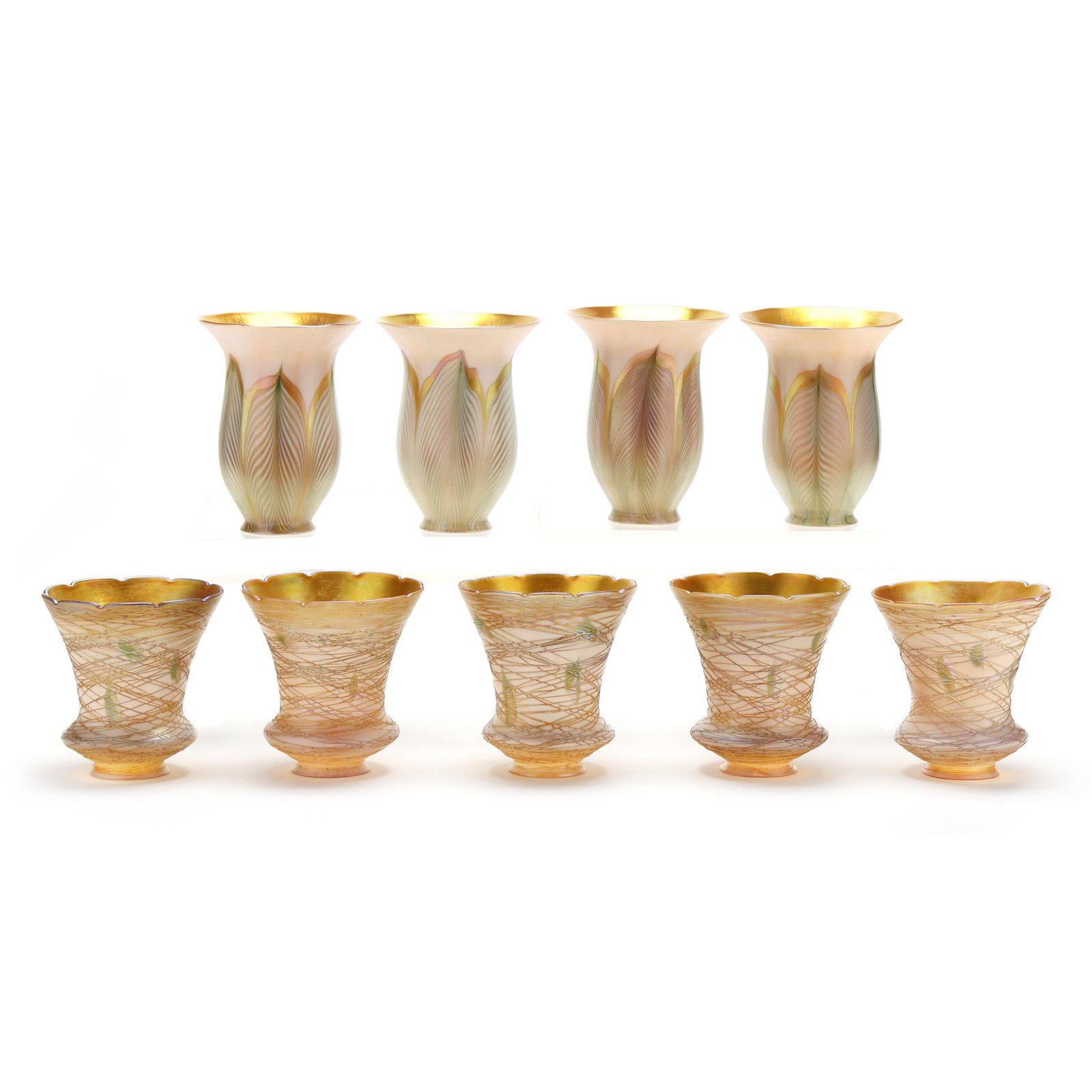 Nine Assorted Quezal Glass Shades: Nine Assorted Quezal Glass Shades New York, early 20th century, including five threaded vine shades in white over gold iridescent glass with scalloped edges (5 in. tall with 2 1/8 in. fitter rim);