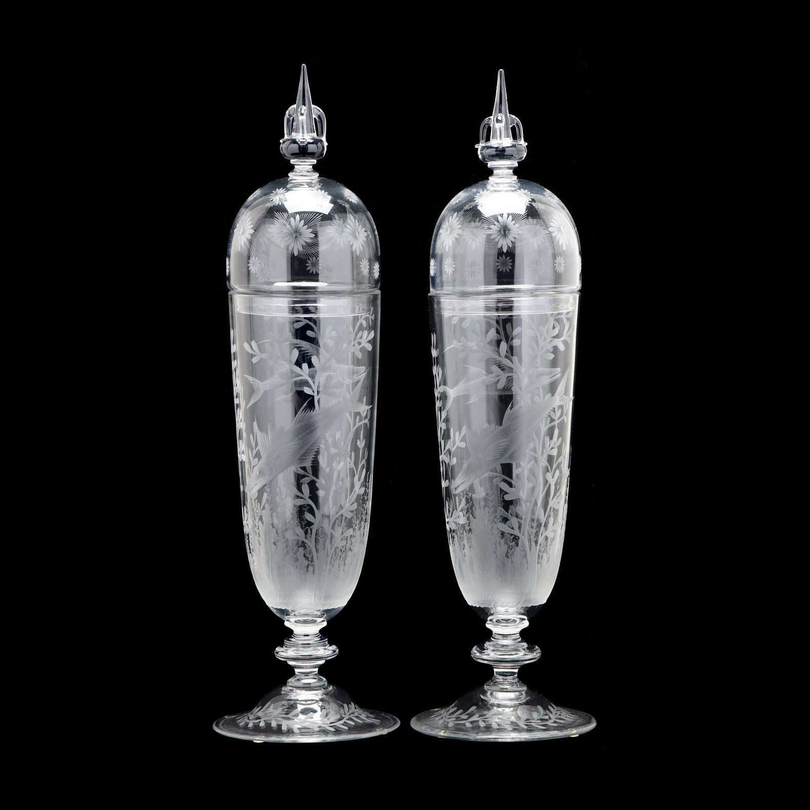 Important Pair of Engraved Steuben Lidded Jars: Important Pair of Engraved Steuben Lidded Jars clear blown glass with tripled handled spire finial, domed lid with engraved starburst motifs, the long bell jar with fine engraved gar fish and