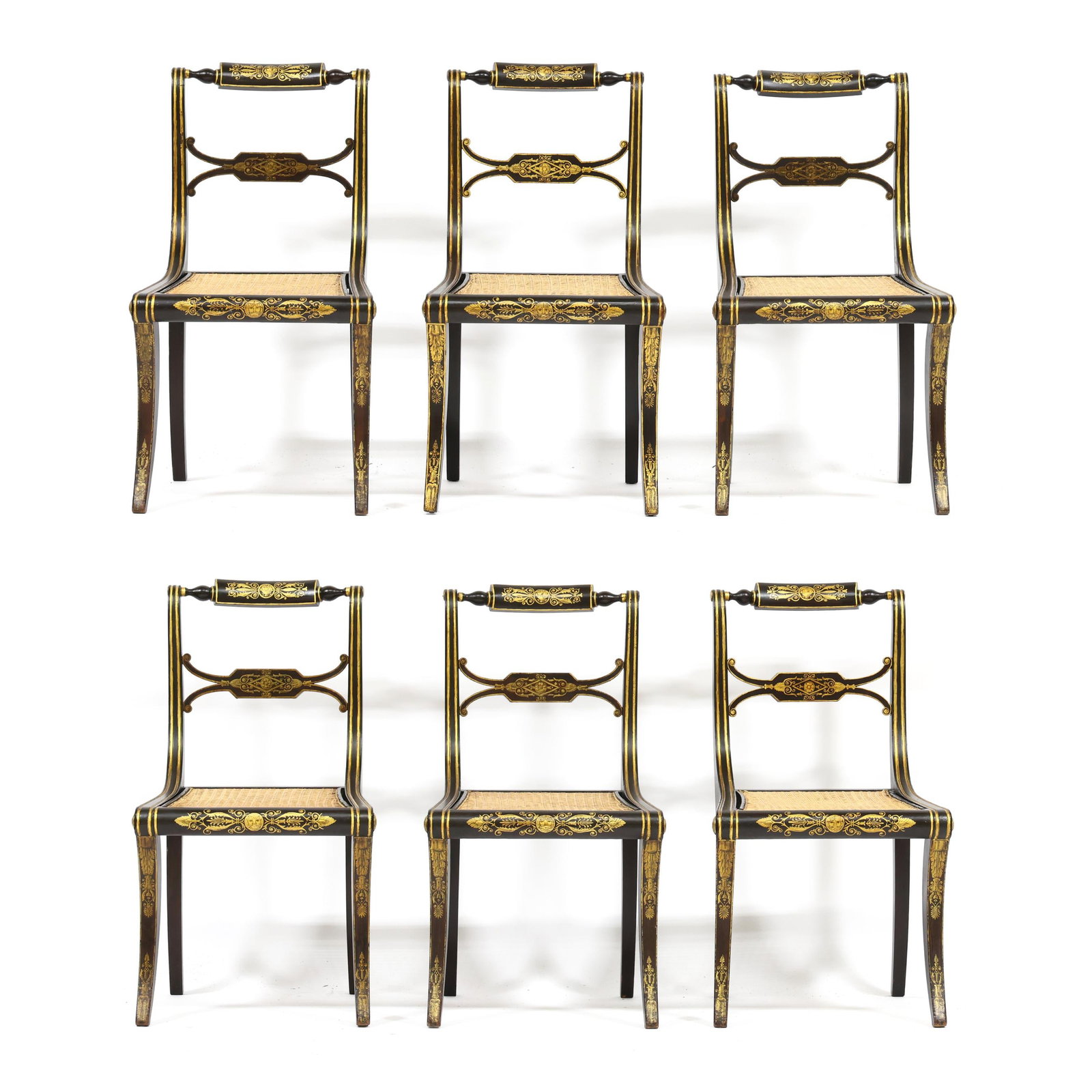 Set of Six Regency Painted and Gilt Dining Chairs: Set of Six Regency Painted and Gilt Dining Chairs early 19th century, faux grain painted surface with gilt highlights, turned and shaped panel crest rail with rectangular and pierced back splat, cane