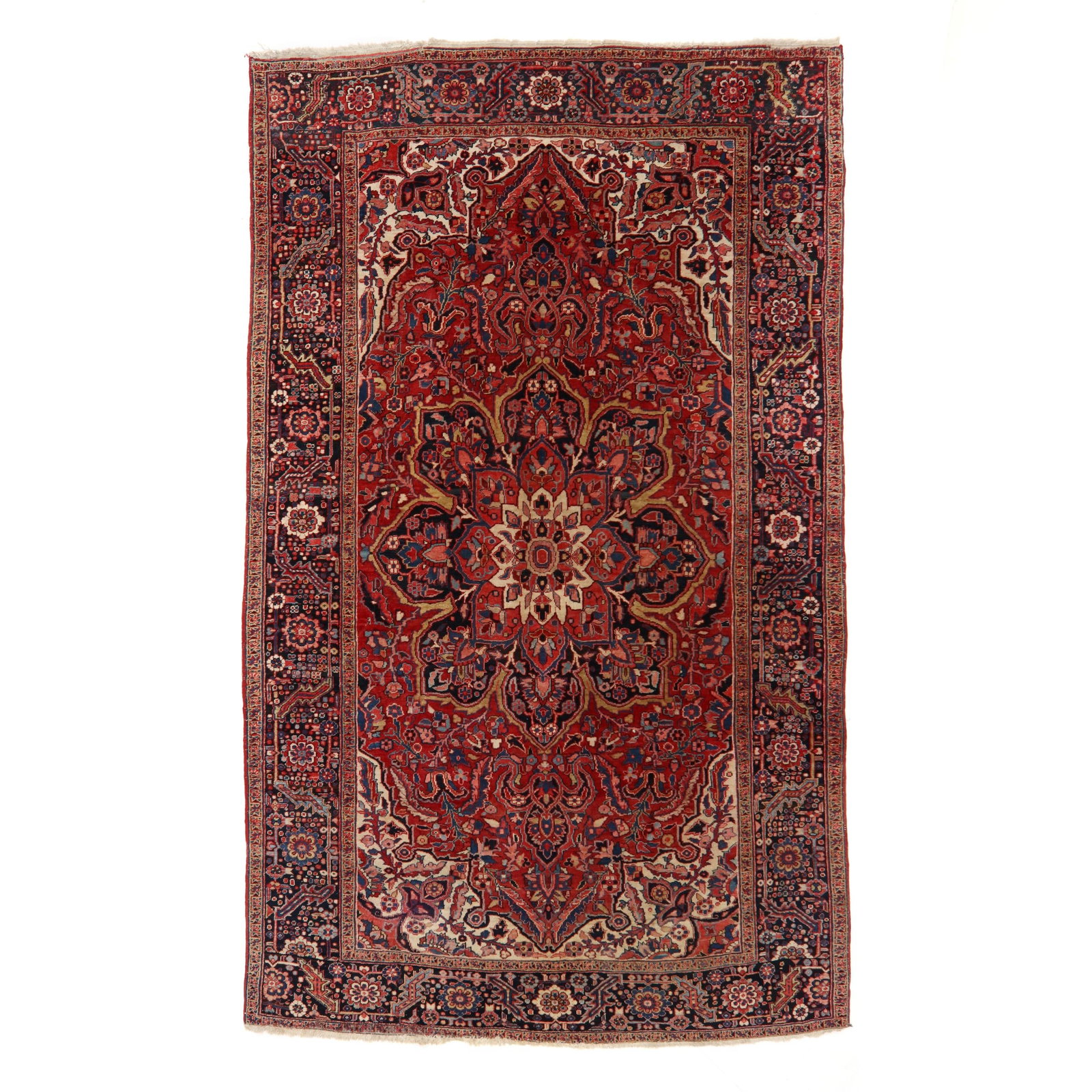 Fine Vintage Heriz Room Size Carpet: Fine Vintage Heriz Room Size Carpet wool on cotton foundation; the red field with starburst medallion in tans, black, blue, and pink, the field and the cream spandrels with stylized foliate motifs,