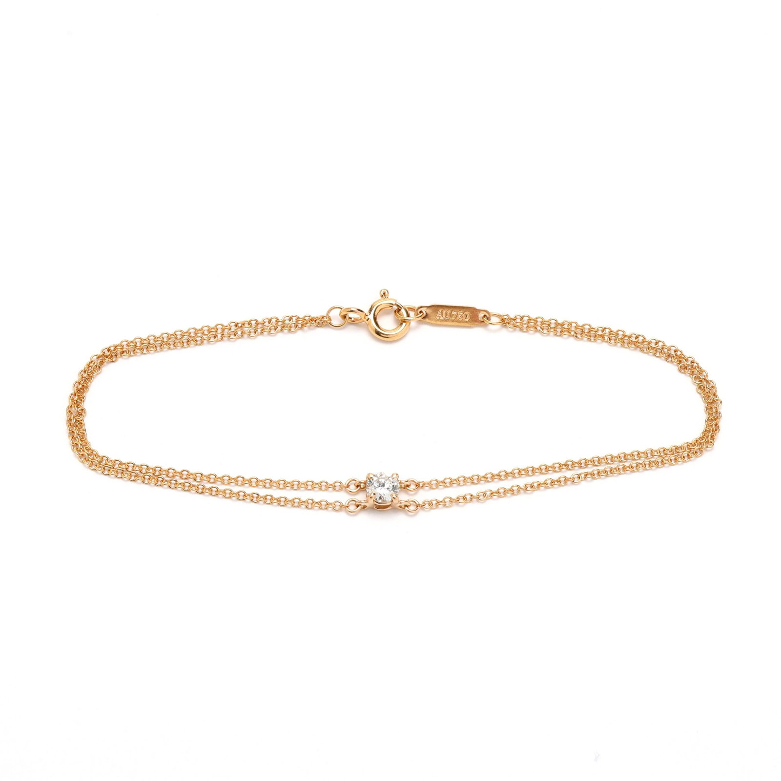 Gold and Diamond Solitaire Bracelet, Tiffany & Co.: Gold and Diamond Solitaire Bracelet, Tiffany & Co. the gold double cable link bracelet prong set to the center with a full cut round diamond (3.64 - 3.67 x 2.25mm) weighing approximately .18 carat (G 
