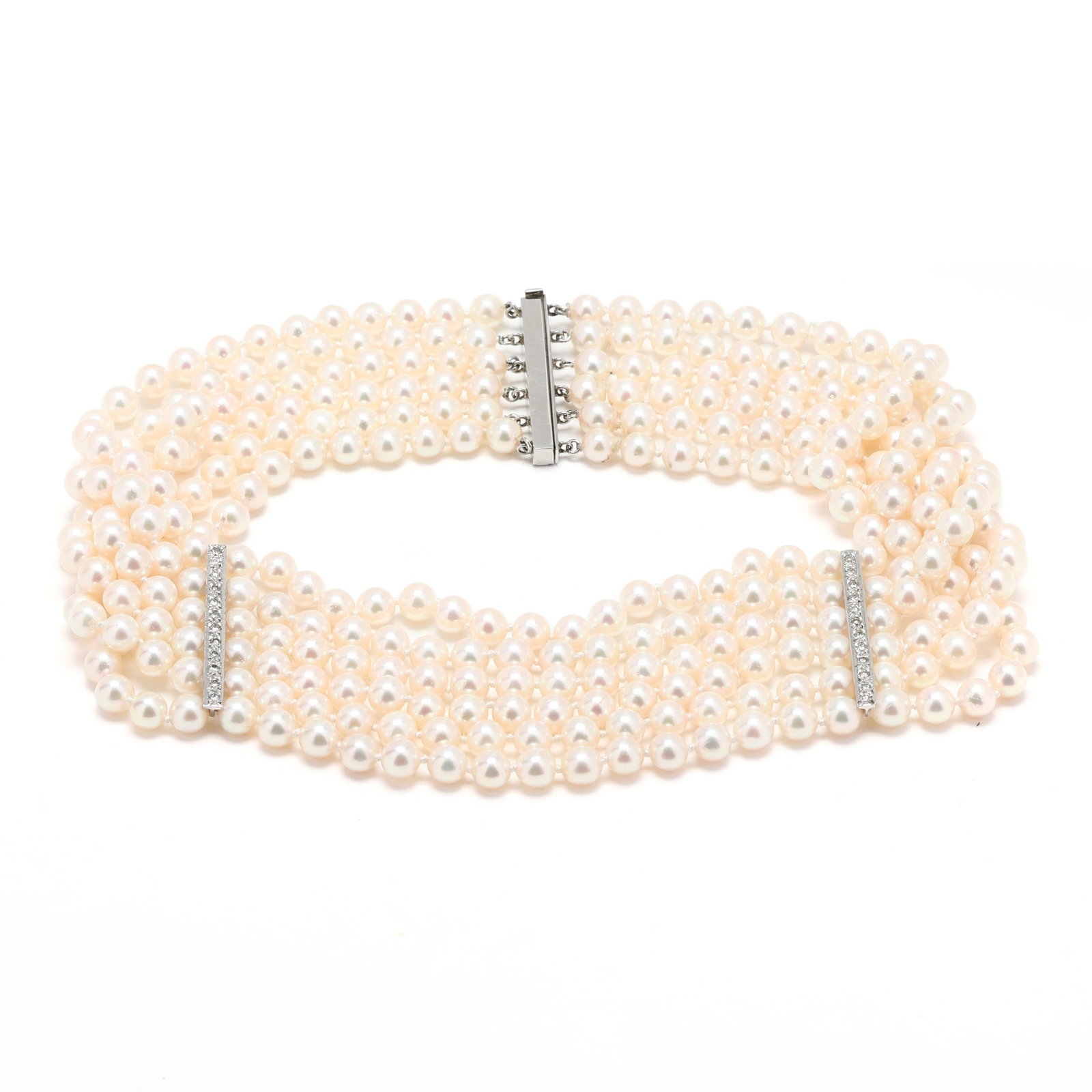 Multi-Strand Pearl Choker with White Gold and Diamond Stations: Multi-Strand Pearl Choker with White Gold and Diamond Stations strung knotted with (6) strands of (51), (51), (52), (52), (52), and (53) round pearls (5.5 - 6.0mm), and with two white gold bars and ma