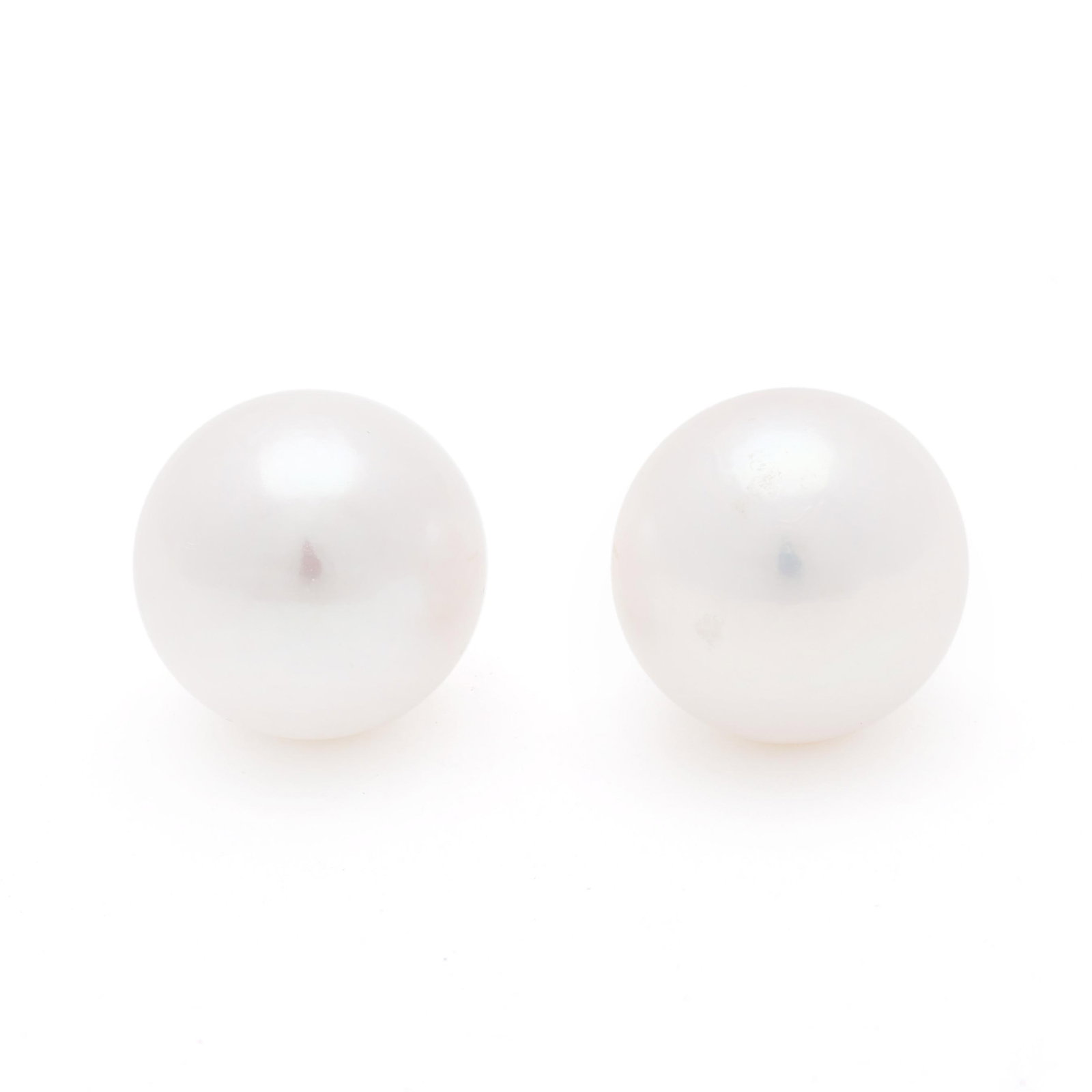 South Sea Pearl Stud Earrings: South Sea Pearl Stud Earrings the round South Sea pearls (14.2mm; 14.0mm) completed with gold posts, stamped Au750. 5.0 dwt. Pearls display a white bodycolor with rose overtones, excellent luster, mod
