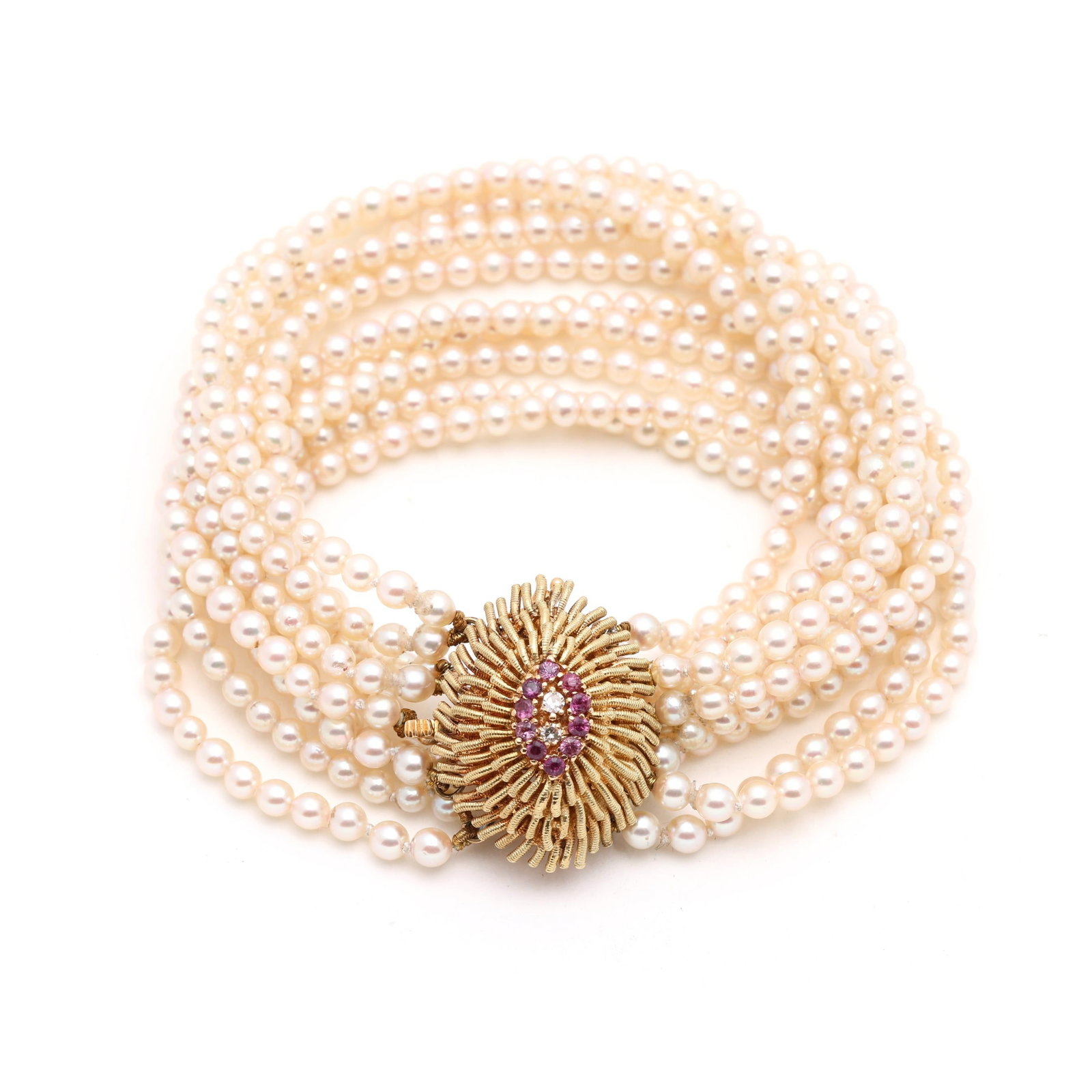 Gold and Gem-Set Multi-Strand Pearl Bracelet: Gold and Gem-Set Multi-Strand Pearl Bracelet the bracelet strung with (ten strands of round pearls (3.0 - 3.5mm), completed with a gold navette form box clasp centered on a cluster of round cut pink s