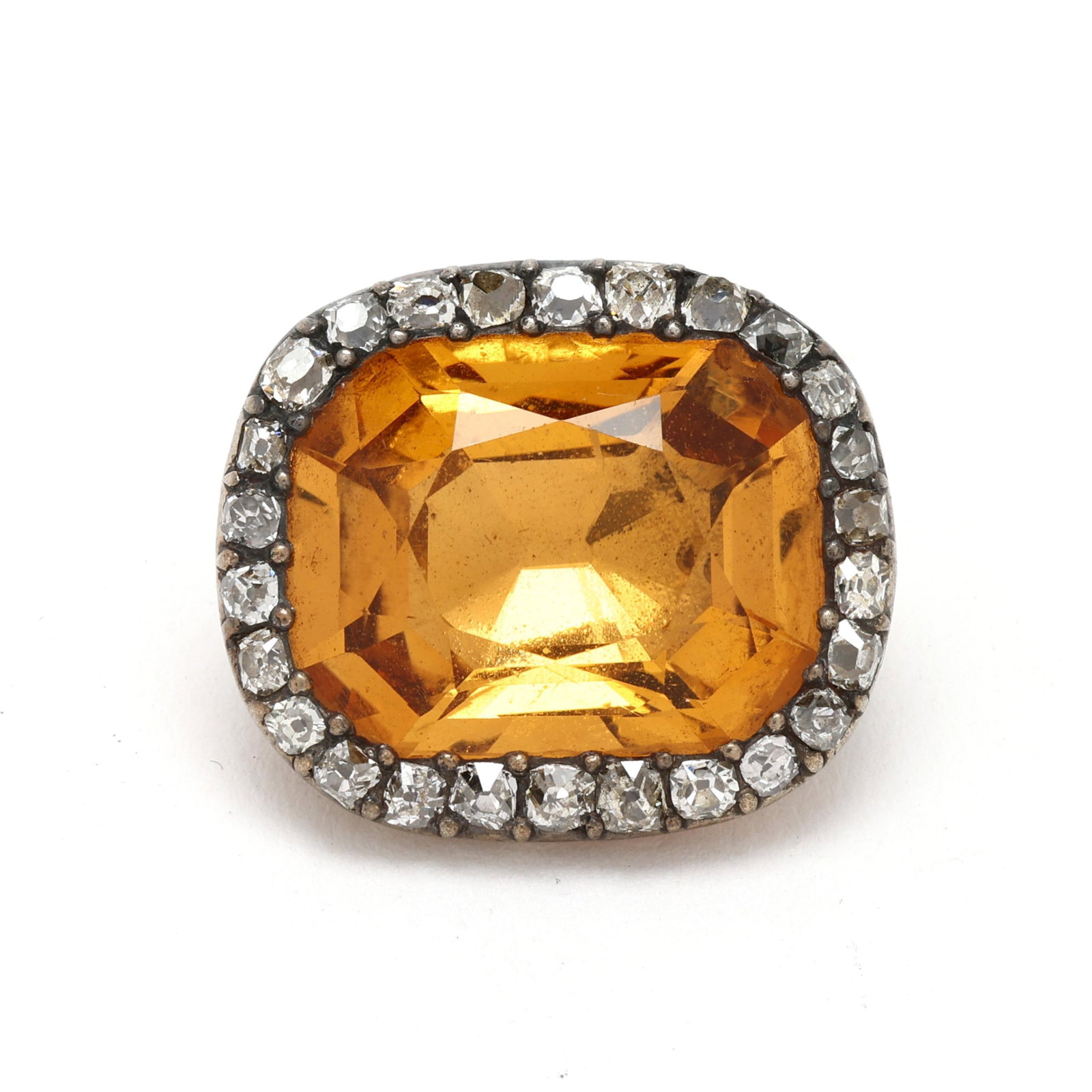 Antique Gold, Topaz, and Diamond Brooch: Antique Gold, Topaz, and Diamond Brooch centered on a rectangular cushion cut topaz (17.4 x 13.8mm) set within a surround of old mine cut diamonds weighing approximately .85 total carat (K-L color, VS