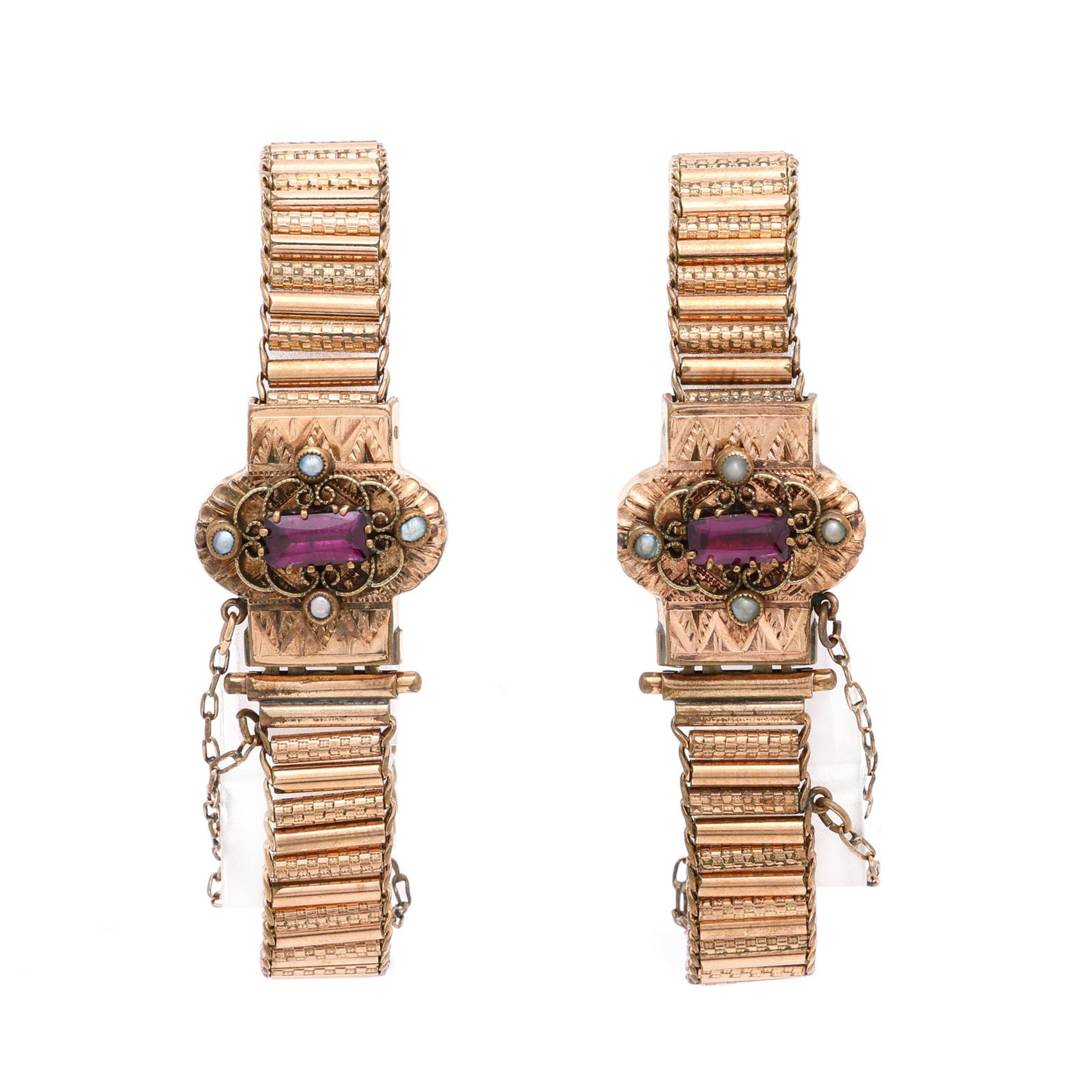 Pair of Gold-Filled Bracelets: Pair of Gold-Filled Bracelets each tube link bracelet completed with a box clasp centered on a rectangular cut garnet with scrolled motif set with round seed pearls, and stamped triangular motif, and 
