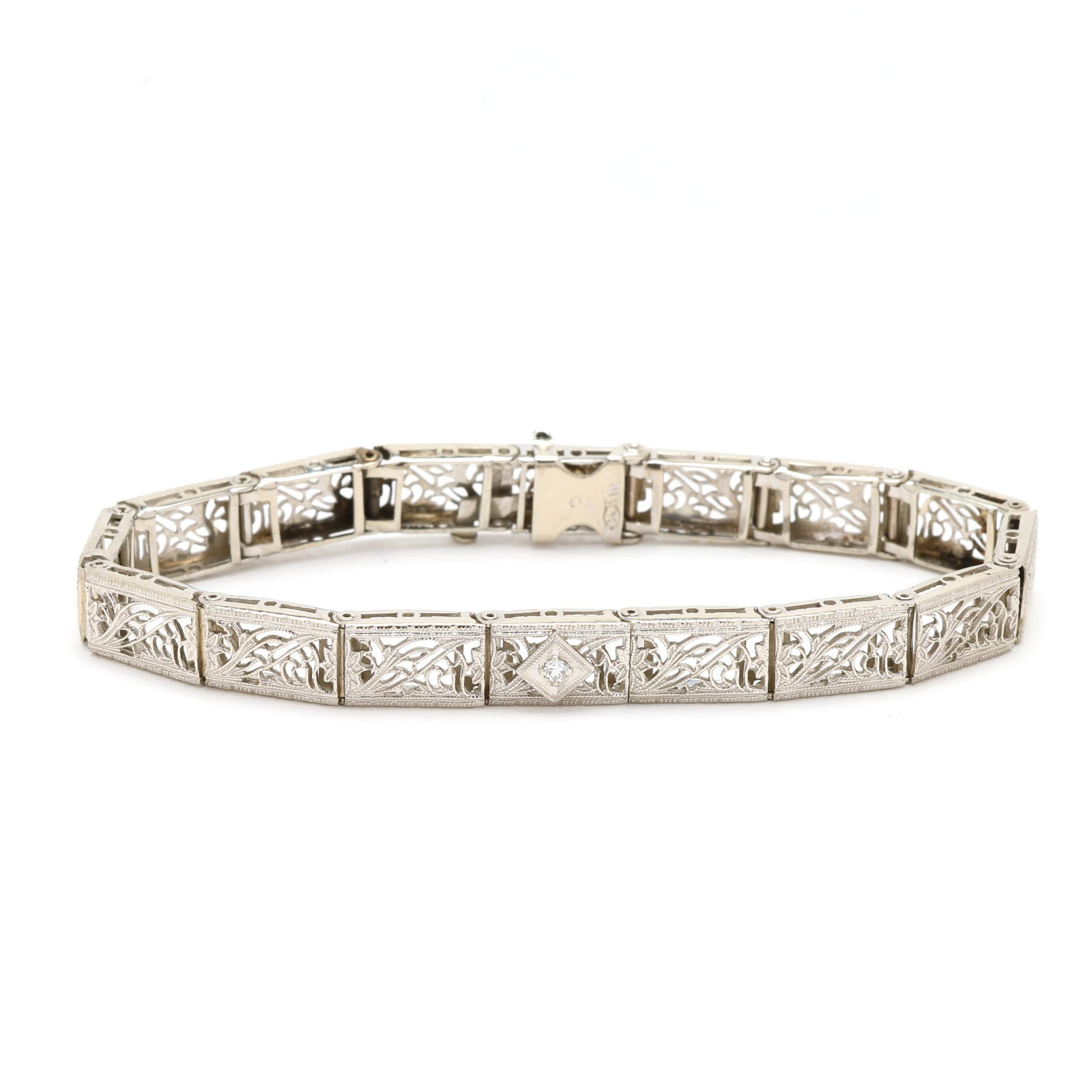 Antique White Gold and Diamond Bracelet: Antique White Gold and Diamond Bracelet the bracelet centering on a transitional cut diamond (2mm) and comprised of (16) white gold filigree links, completed with an integrated clasp with latch,