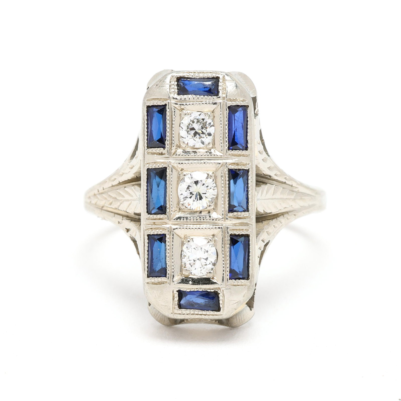 Antique White Gold, Diamond, and Synthetic Sapphire Ring: Antique White Gold, Diamond, and Synthetic Sapphire Ring three stone ring vertically set with full cut round diamonds weighing approximately .20 total carat (G-H color, VS2-SI1 clarity) within a
