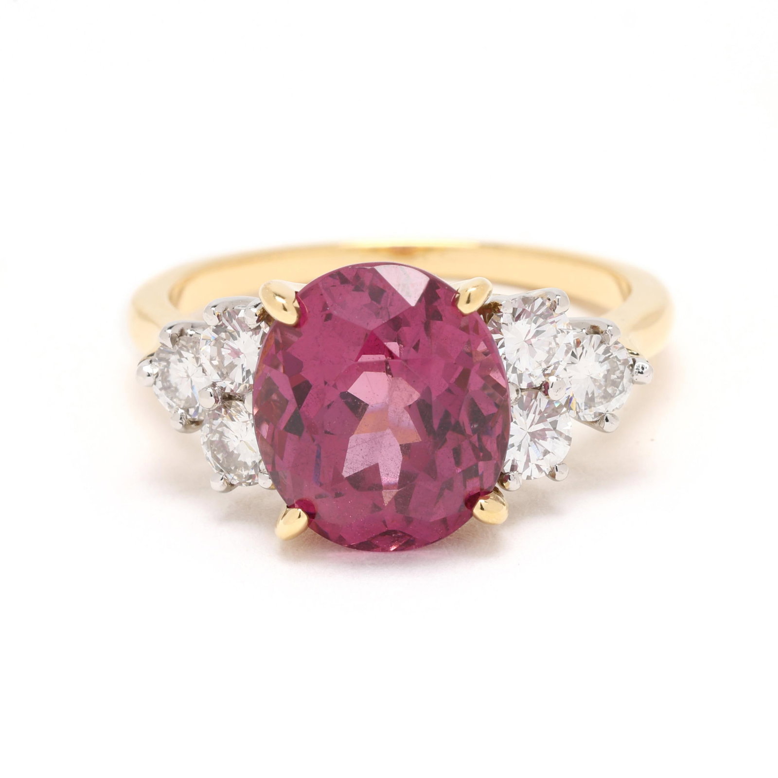 Gold, Pyrope Garnet, and Diamond Ring: Gold, Pyrope Garnet, and Diamond Ring centered on an oval cut pyrope garnet (10.1 x 8.7 x 6.43mm) weighing approximately 4.5 carats, set to each side with full cut round diamonds weighing