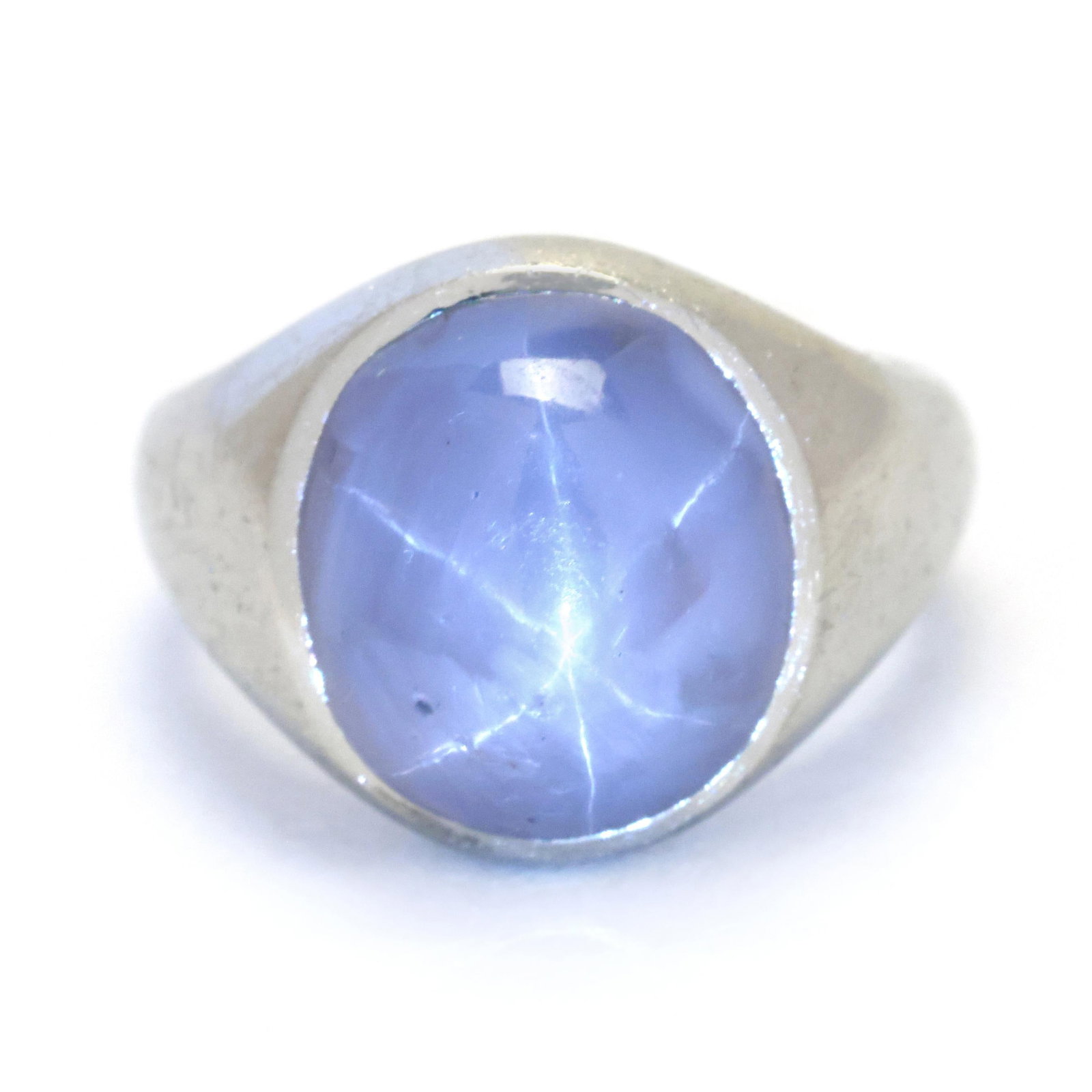 White Gold and Star Sapphire Ring: White Gold and Star Sapphire Ring centered on an oval cabochon cut star sapphire (11.5 x 10.3mm), with parital stamp, XRF testing 18KT. 13.4mm; Ring size 3.75 5.2 dwt. Sapphire displays a strong, slig