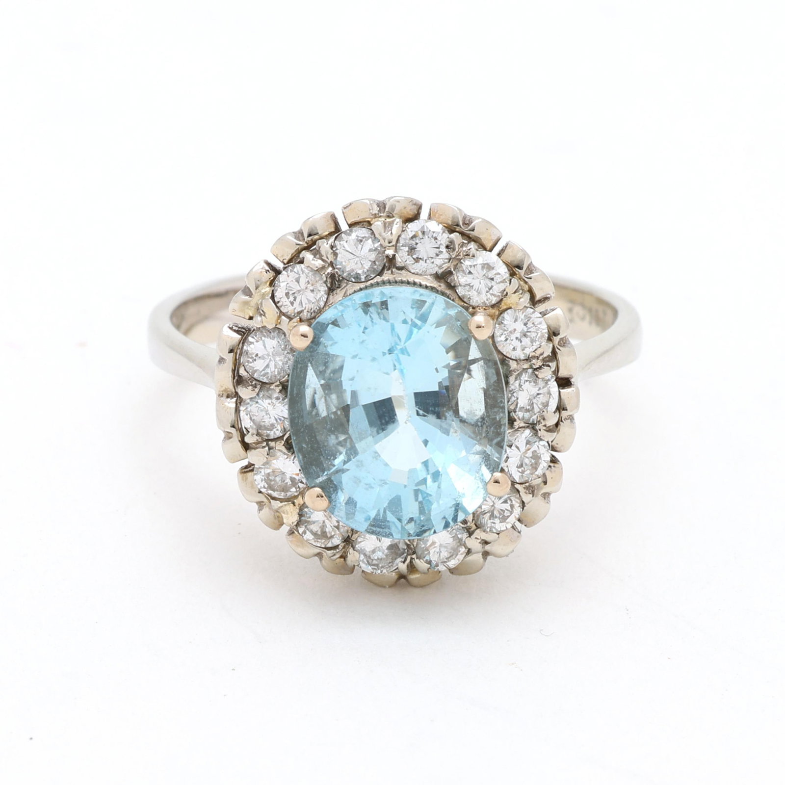 White Gold, Aquamarine, and Diamond Ring: White Gold, Aquamarine, and Diamond Ring centered on a prong set oval cut aquamarine (10.0 x 8.5 x 6.35mm) weighing 3.01 carats, within a halo of full cut round diamonds weighing approximately .56 tot