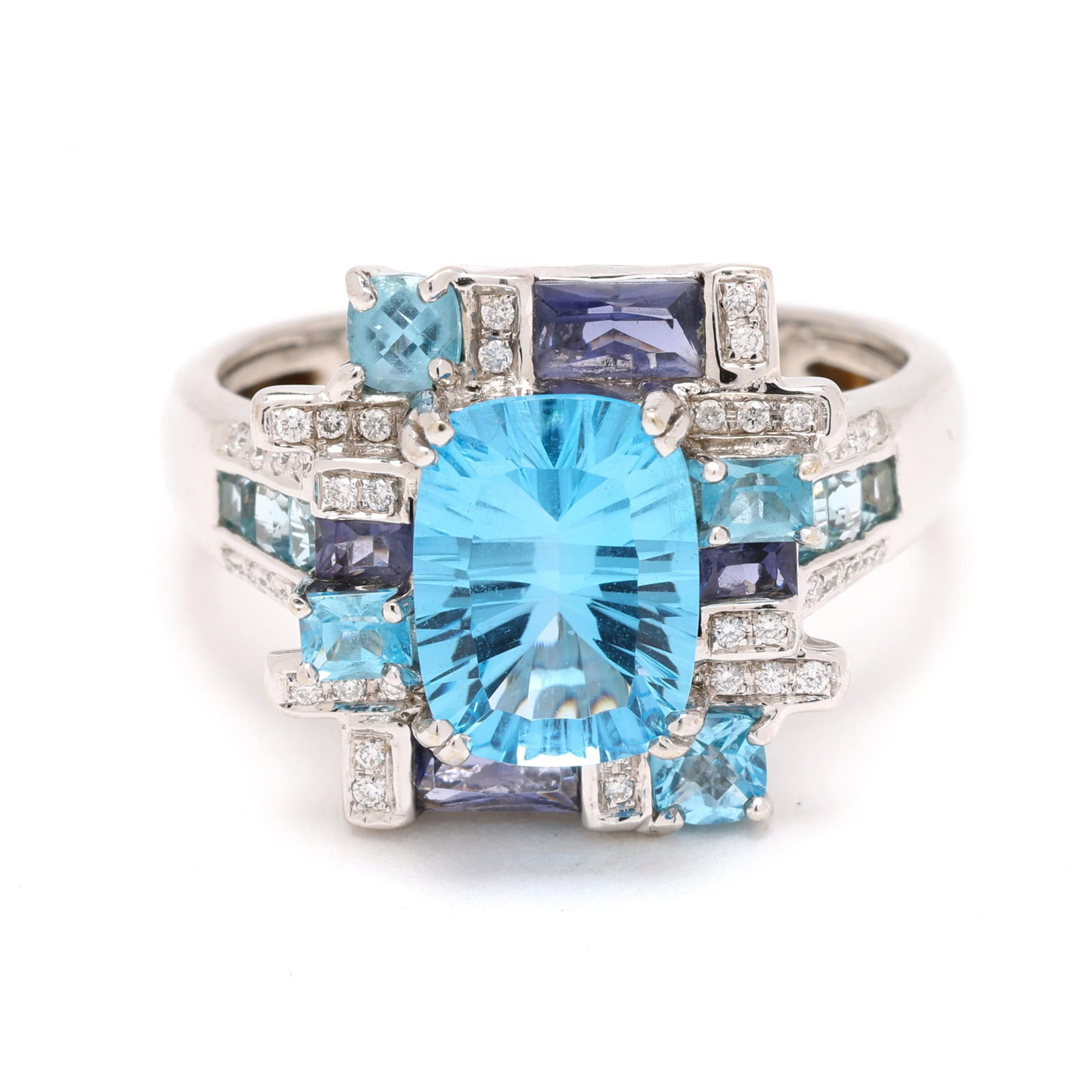 White Gold, Blue Topaz, Iolite, and Diamond Ring: White Gold, Blue Topaz, Iolite, and Diamond Ring centered on a rectangular cushion cut topaz (10.11 x 7.62 x 4.96mm) weighing approximately 3.00 carats within a geometric motif surround set with