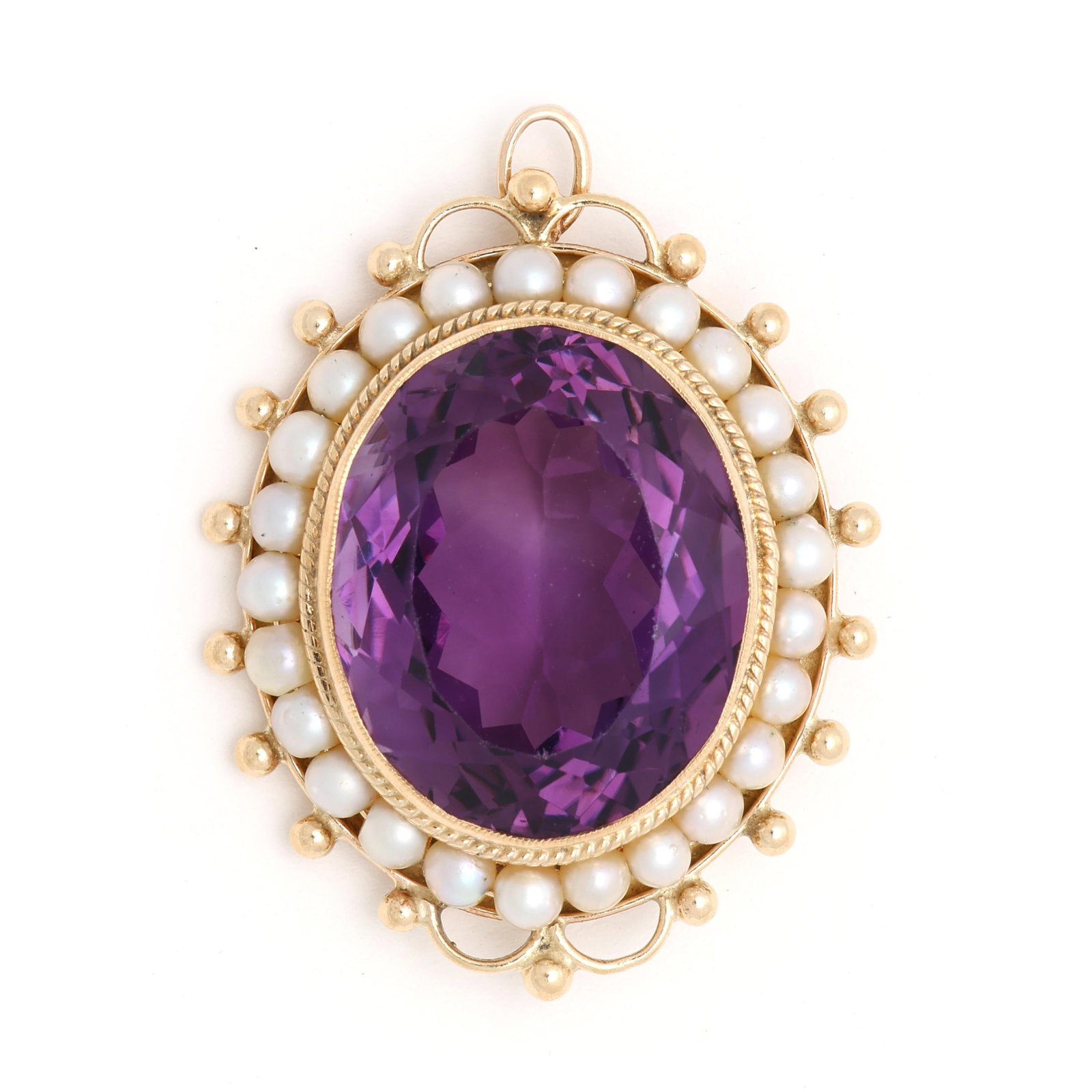 Gold, Amethyst, and Pearl Brooch / Pendant: Gold, Amethyst, and Pearl Brooch / Pendant centered on an oval cut amethyst (21.5 x 17.5 x 11.3mm) weighing approximately 23.5 carats set within a surround of round seed pearls within a beaded