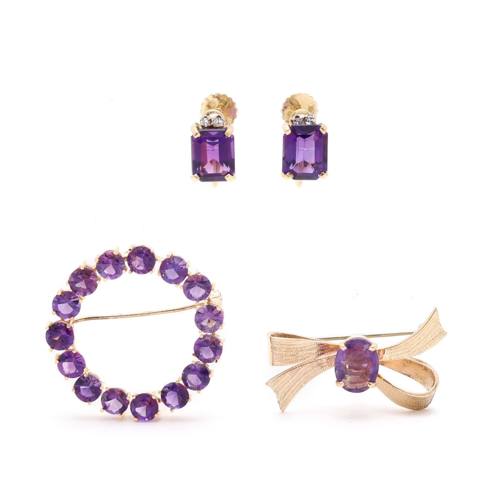 Group of Gold and Amethyst Jewelry: Group of Gold and Amethyst Jewelry to include: a circle brooch set with round cut amethysts (5.1mm) completed with a locking pin stem, stamped 18K / 750 (1.25 in.); a gold bow brooch, set to the
