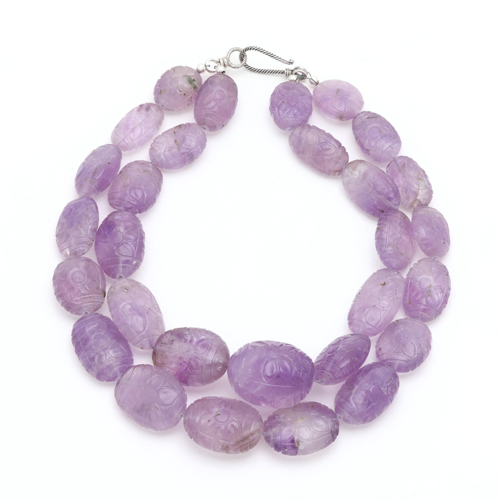 Carved Amethyst Bead Necklace: Carved Amethyst Bead Necklace the necklace composed of oval amethyst beads with floral carvings, completed with a silver-toned hook clasp in a cable motif, and XRF testing sterling silver. 19.75 in.