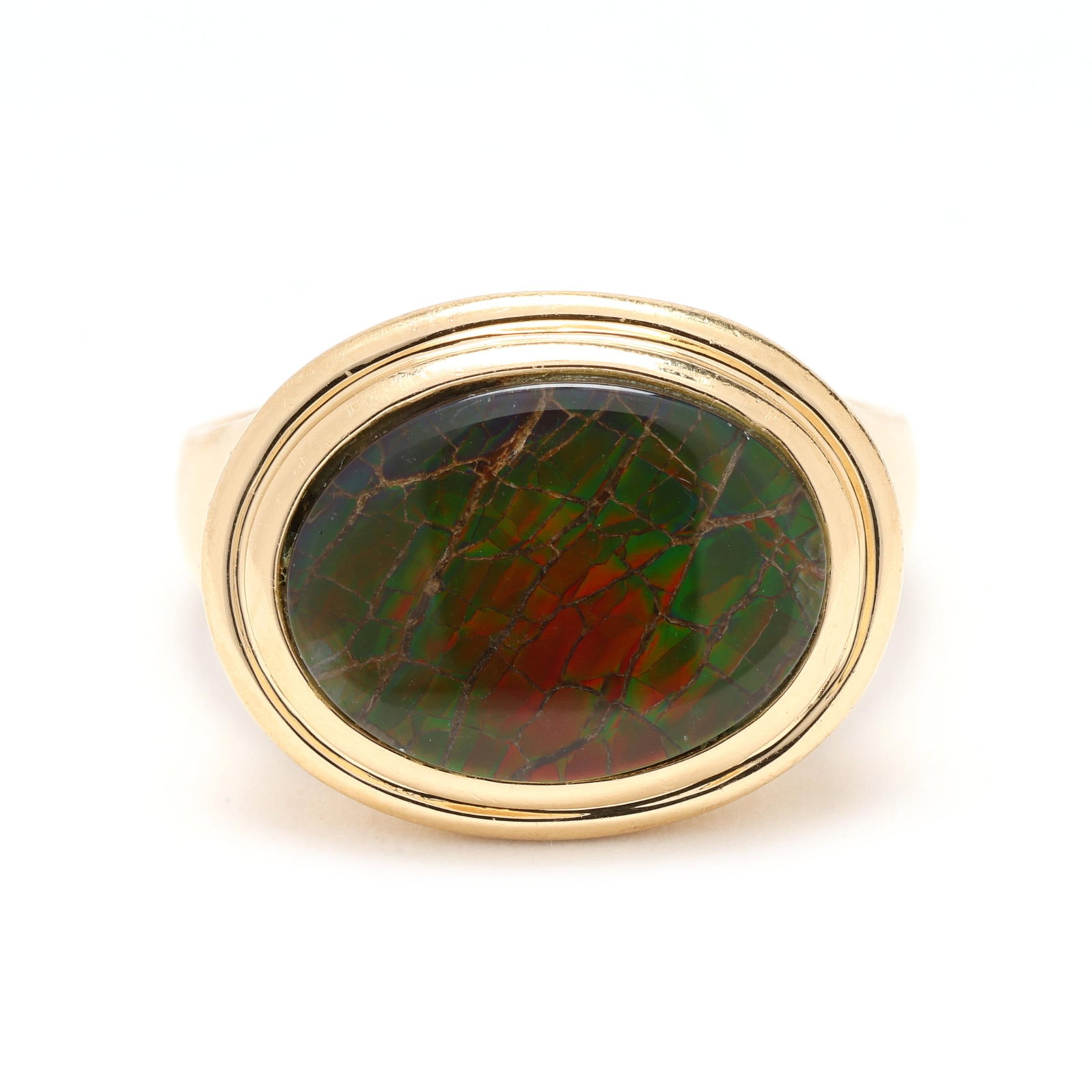 Gold and Ammolite Ring: Gold and Ammolite Ring centered on a bezel set oval cut ammolite triplet (16.1 x 12.1mm), stamped 14K and with a maker's mark. 16.78 x 21mm; Ring size 11 5.6 dwt. From the Estate of the late Ronald