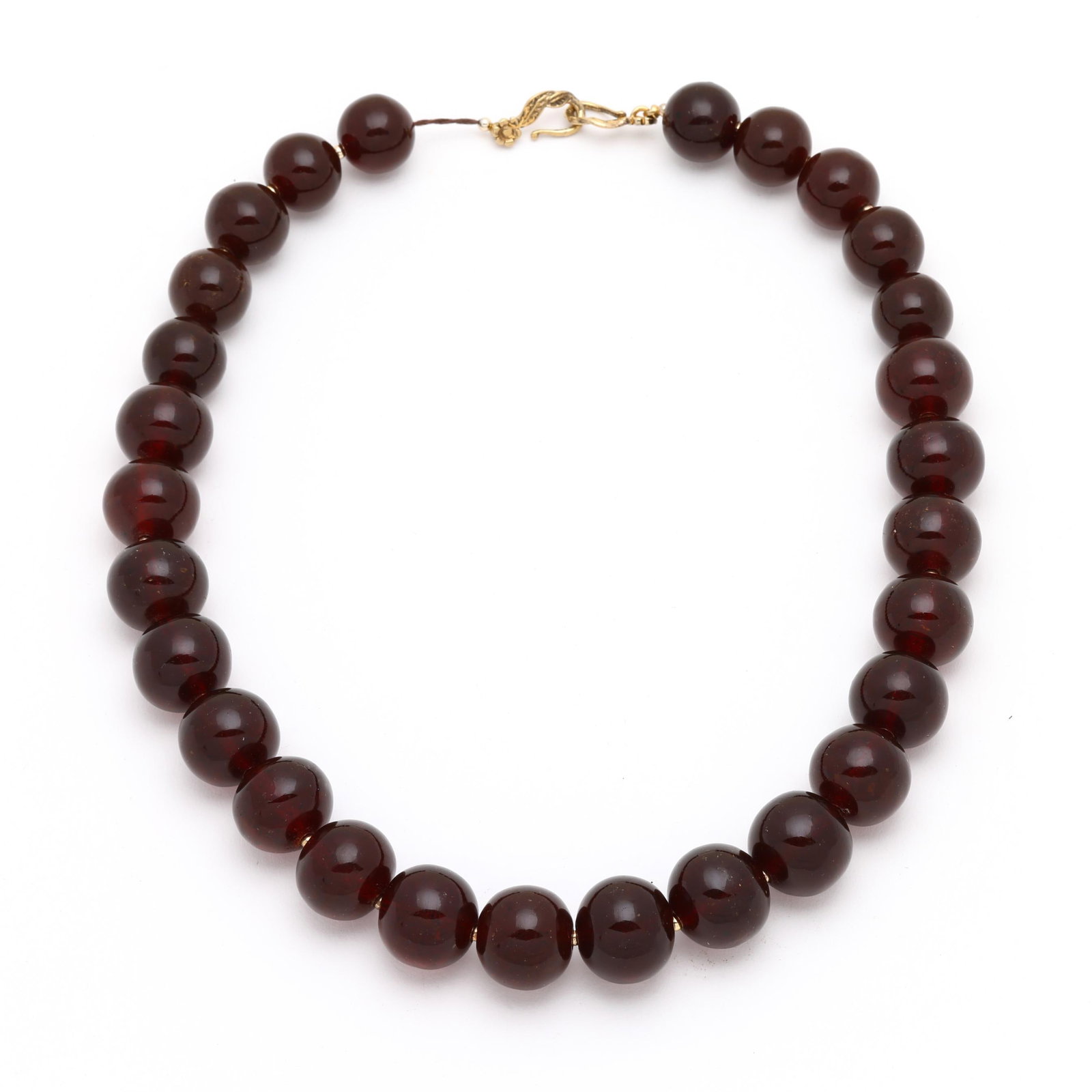 Graduated Amber Bead Necklace: Graduated Amber Bead Necklace the necklace comprised of graduated amber beads (17mm to 20.5mm) and alternating gold-tone bead accents, completed with a gilt hook clasp, and stamped 925. 22.75 in.