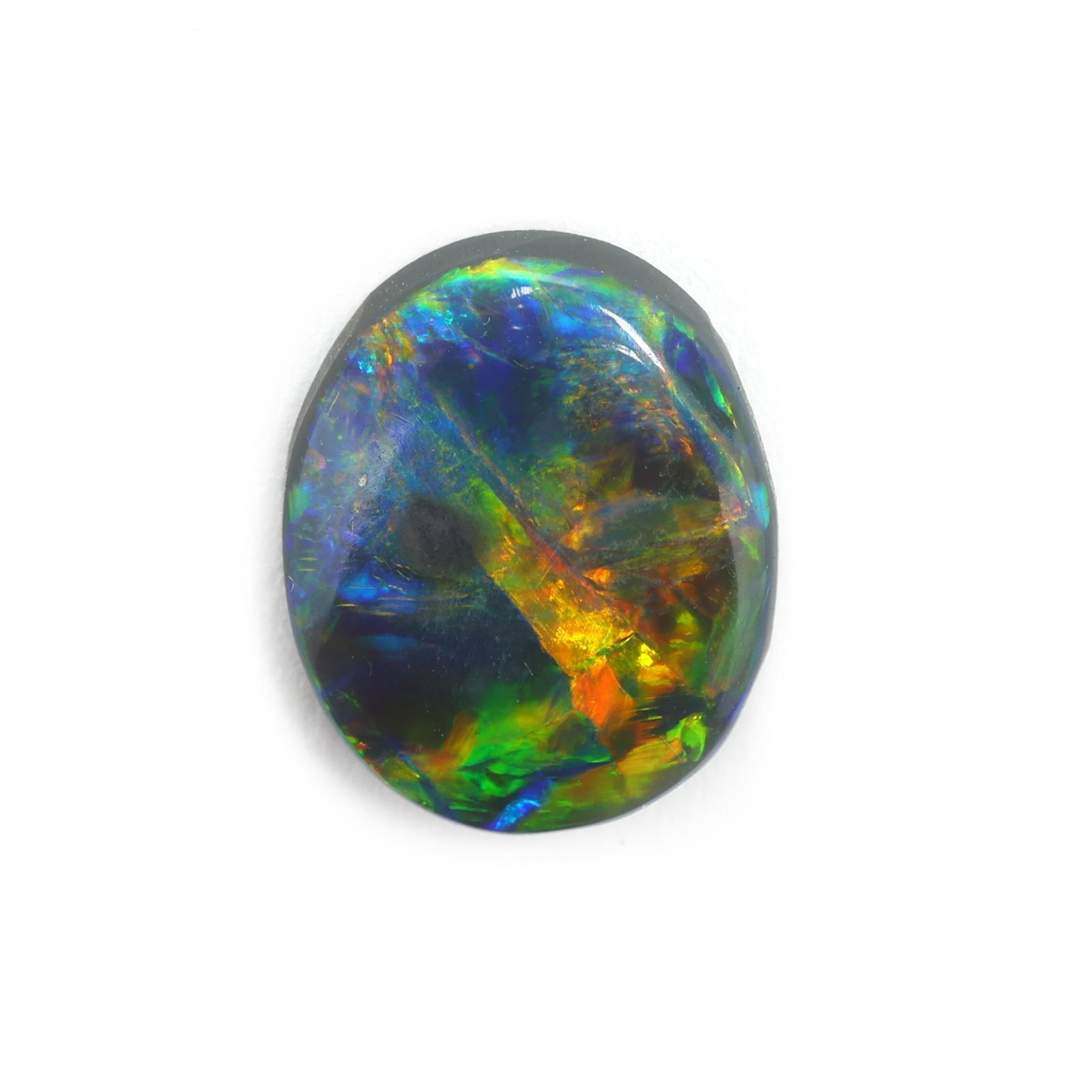 Loose 2.40 Carat Oval Cabochon Cut Opal: Loose 2.40 Carat Oval Cabochon Cut Opal the oval cabochon cut opal (11.81 x 9.66 x 3.17mm) weighing 2.40 carats (actual). Opal displays green, blue, and orange flash play-of-color. Additional