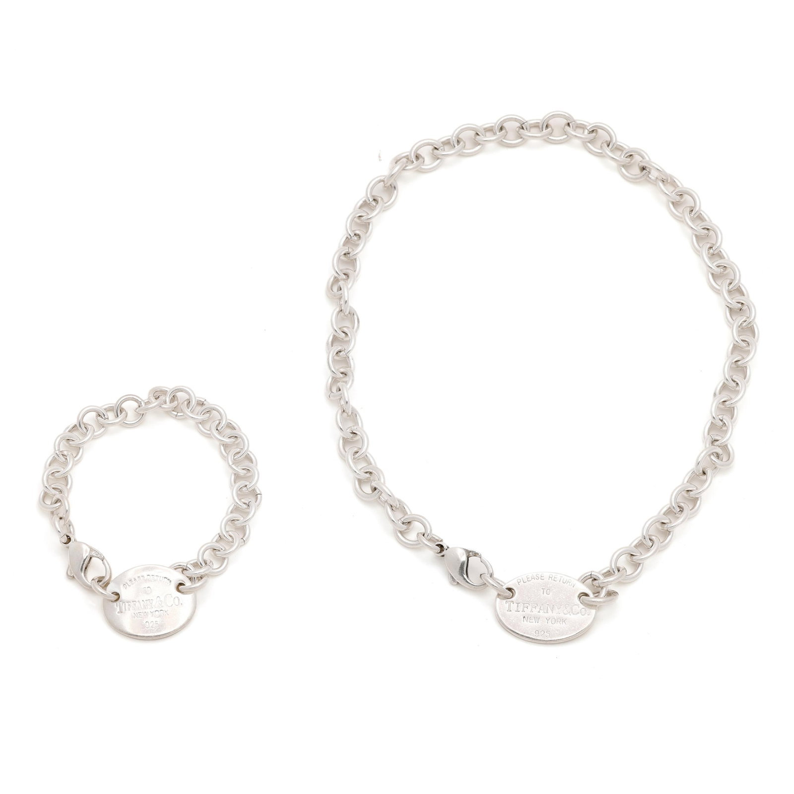 Silver Return to Tiffany Necklace and Bracelet, Tiffany & Co.: Silver Return to Tiffany Necklace and Bracelet, Tiffany & Co. to include: an oval link bracelet suspending a round "Please Return to Tiffany & Co." charm, completed with a lobster clasp, and stamped