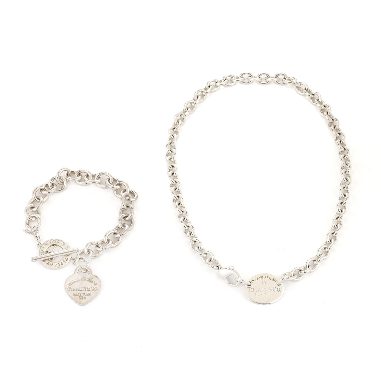 Silver Return to Tiffany Necklace and Bracelet, Tiffany & Co.: Silver Return to Tiffany Necklace and Bracelet, Tiffany & Co. to include: an oval link bracelet suspending a round "Please Return to Tiffany & Co. New York" charm, completed with a toggle clasp, and