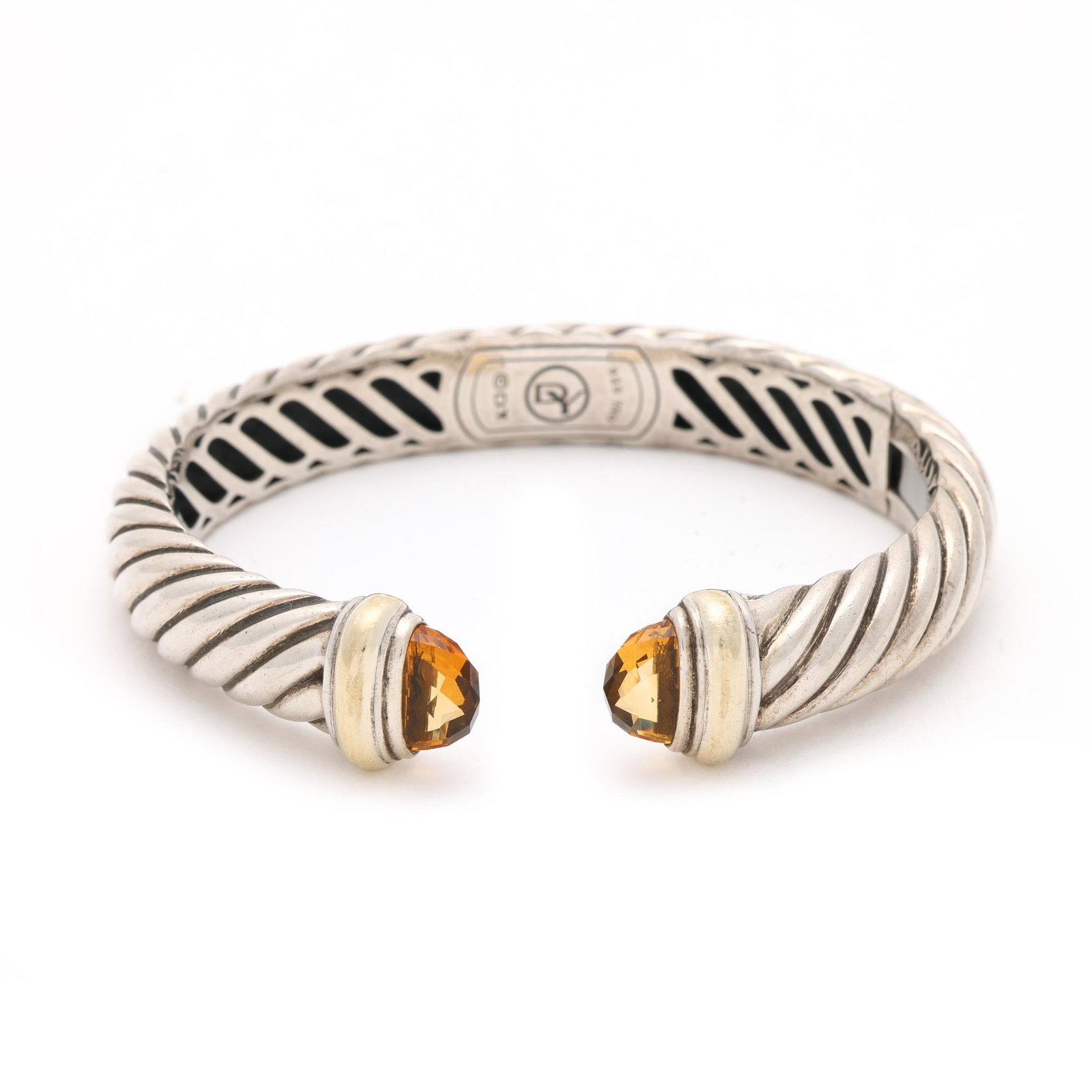 Sterling Silver, Gold, and Citrine Bracelet, David Yurman: Sterling Silver, Gold, and Citrine Bracelet, David Yurman of hinged form, the cable motif bracelet with faceted citrine and gold accent terminals, stamped with maker's mark and 925 750. 3/8 x 5 7/8 in