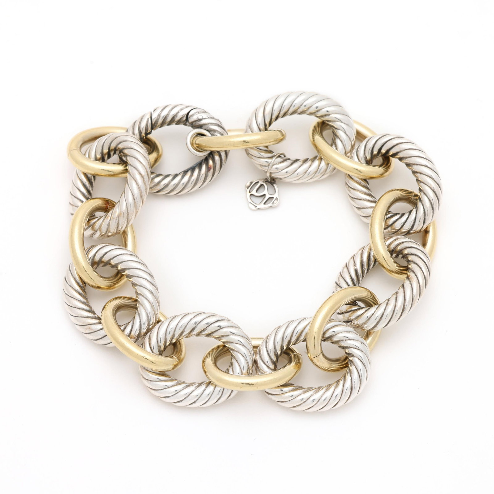 Silver and Gold Oval Link Bracelet, David Yurman: Silver and Gold Oval Link Bracelet, David Yurman the bracelet in alternating silver cable and high polish smooth gold links, completed with an integrated clasp, with signature tag, stamped 750. .75 x 