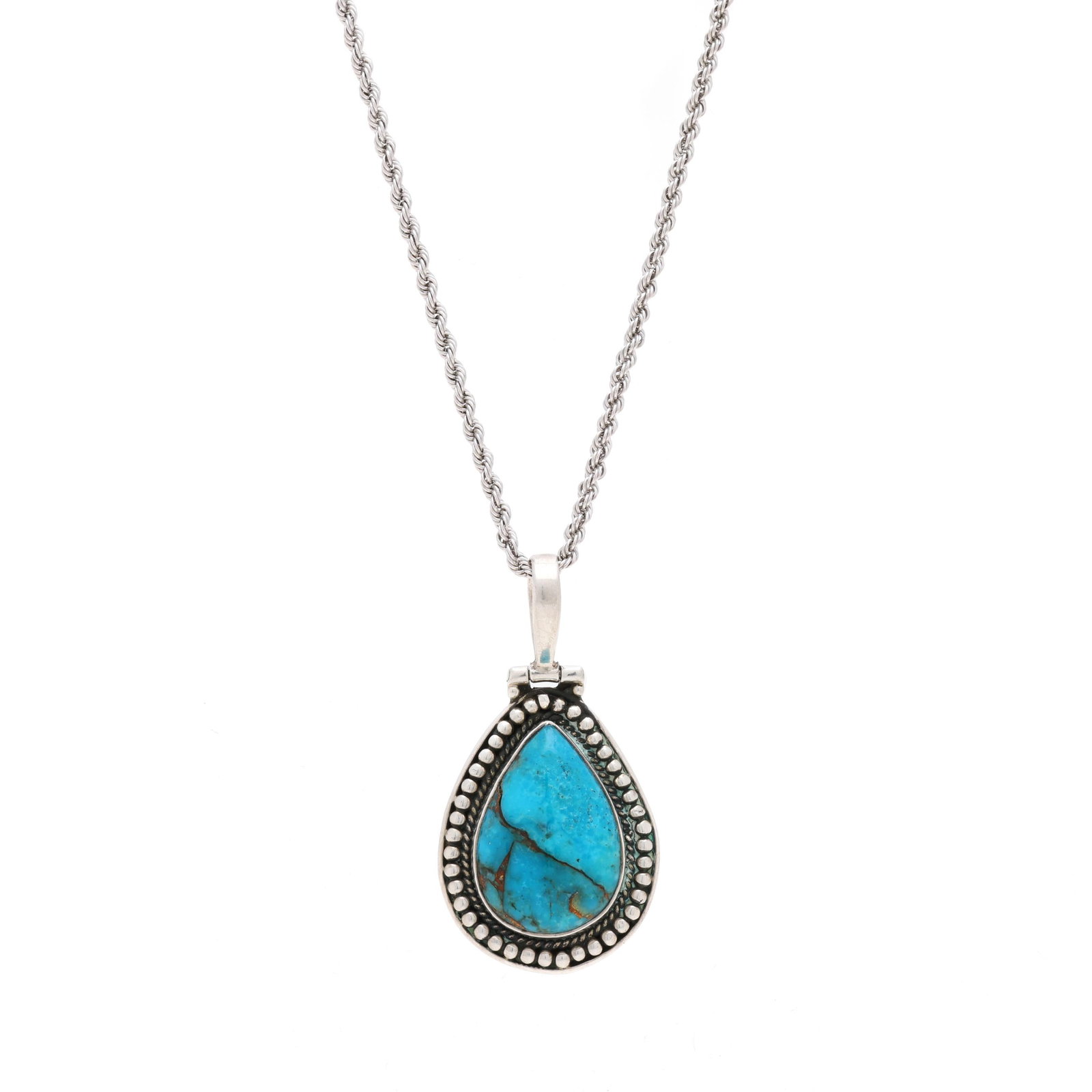 Silver and Turquoise Pendant Necklace: Silver and Turquoise Pendant Necklace the pear-shaped pendant with pear cabochon cut turquoise set within a bead and rope twist motif with a hinged bail, suspended from a rope twist chain completed