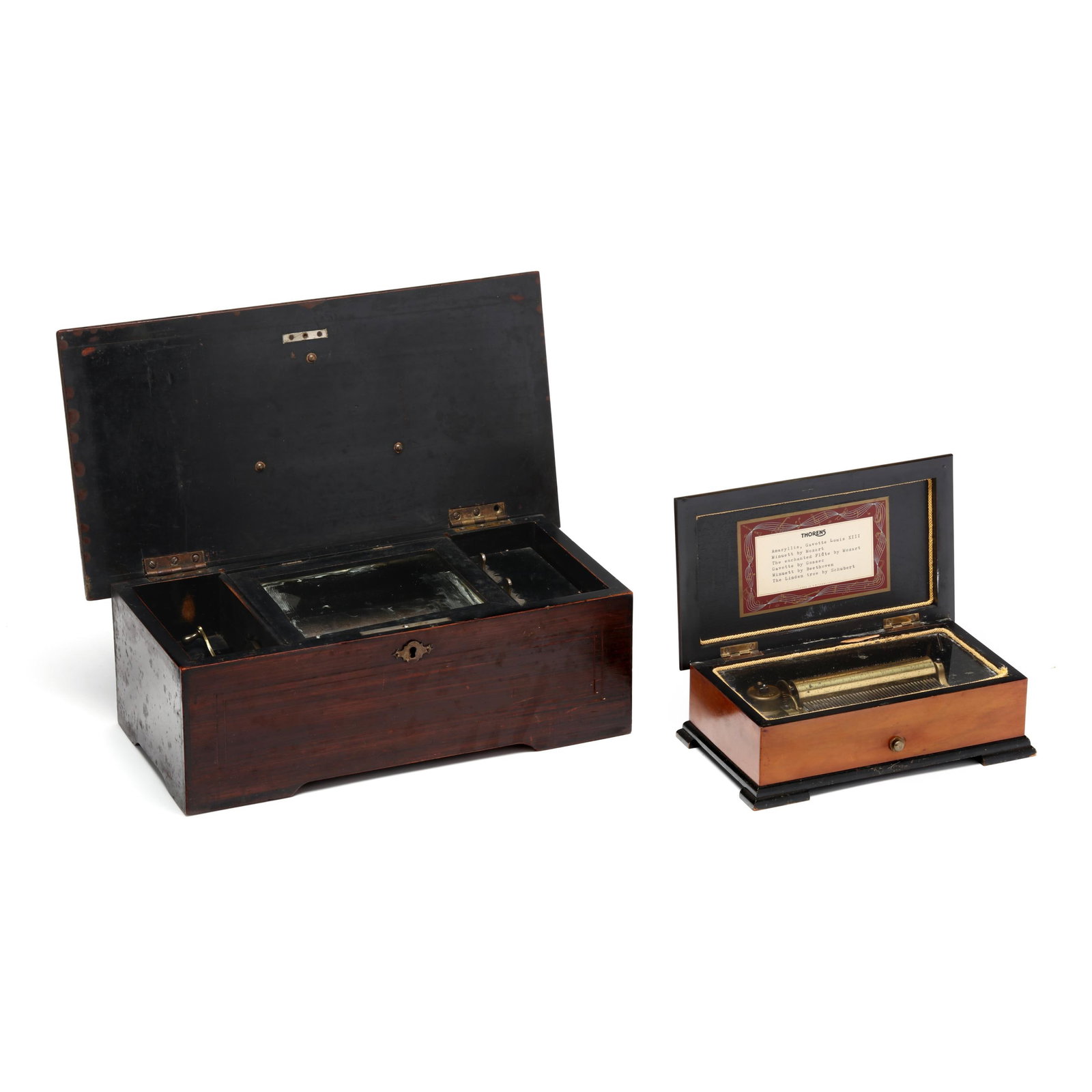 Two Inlaid Swiss Tabletop Music Boxes: Two Inlaid Swiss Tabletop Music Boxes both with single comb and 4 1/2-inch swiss cylinder movements under glass, within a rectangular wooden case, molded hinged lid with bracket feet, the larger circa