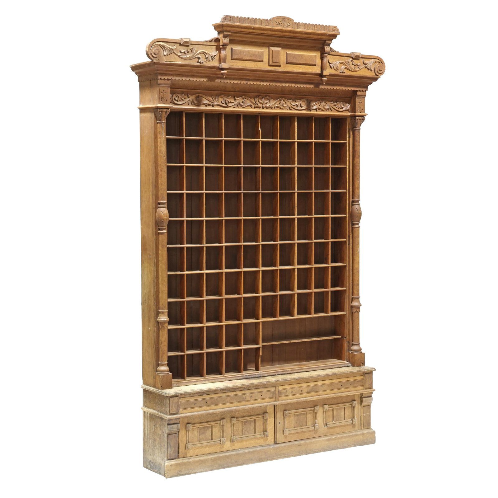 Large Victorian Carved Oak Barber Shop Cabinet: Large Victorian Carved Oak Barber Shop Cabinet late 19th century, two part form with removable cornice, applied carving and incised decoration, upper recessed cabinet with (92) cubby holes for shaving